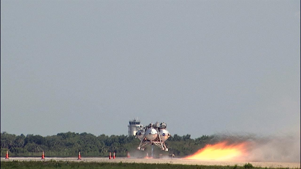 CAPE CANAVERAL, Fla. – NASA's Project Morpheus prototype lander begins to lift off on a free-flight test from a new launch pad at the north end of the Shuttle Landing Facility at NASA’s Kennedy Space Center in Florida. The 98-second test began at 3:20 p.m. EDT with the Morpheus lander launching from the ground over a flame trench and ascending more than 800 feet at a peak speed of 36 mph. The vehicle, with its recently installed autonomous landing and hazard avoidance technology ALHAT sensors, surveyed the hazard field to determine safe landing sites. Morpheus then flew forward and downward covering approximately 1300 feet while performing a 78-foot divert to simulate a hazard avoidance maneuver. The lander then descended and landed on a dedicated pad inside the autonomous landing and hazard avoidance technology hazard field. Project Morpheus tests NASA’s ALHAT and an engine that runs on liquid oxygen and methane, which are green propellants. These new capabilities could be used in future efforts to deliver cargo to planetary surfaces. The landing facility provides the lander with the kind of field necessary for realistic testing, complete with rocks, craters and hazards to avoid. Morpheus’ ALHAT payload allows it to navigate to clear landing sites amidst rocks, craters and other hazards during its descent. Project Morpheus is being managed under the Advanced Exploration Systems, or AES, Division in NASA’s Human Exploration and Operations Mission Directorate. The efforts in AES pioneer new approaches for rapidly developing prototype systems, demonstrating key capabilities and validating operational concepts for future human missions beyond Earth orbit. For more information on Project Morpheus, visit http://morpheuslander.jsc.nasa.gov/. Photo credit: NASA/Chris Chamberland