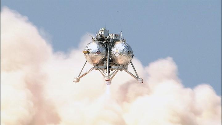 CAPE CANAVERAL, Fla. – NASA's Project Morpheus prototype lander descends toward the autonomous landing and hazard avoidance field after a free-flight test from a new launch pad at the north end of the Shuttle Landing Facility at NASA's Kennedy Space Center in Florida. The 98-second test began at 3:20 p.m. EDT with the Morpheus lander launching from the ground over a flame trench and ascending more than 800 feet at a peak speed of 36 mph. The vehicle, with its recently installed autonomous landing and hazard avoidance technology ALHAT sensors, surveyed the hazard field to determine safe landing sites. Morpheus then flew forward and downward covering approximately 1300 feet while performing a 78-foot divert to simulate a hazard avoidance maneuver. The lander then descended and landed on a dedicated pad inside the autonomous landing and hazard avoidance technology hazard field. Project Morpheus tests NASA’s ALHAT and an engine that runs on liquid oxygen and methane, which are green propellants. These new capabilities could be used in future efforts to deliver cargo to planetary surfaces.     The landing facility provides the lander with the kind of field necessary for realistic testing, complete with rocks, craters and hazards to avoid. Morpheus’ ALHAT payload allows it to navigate to clear landing sites amidst rocks, craters and other hazards during its descent. Project Morpheus is being managed under the Advanced Exploration Systems, or AES, Division in NASA’s Human Exploration and Operations Mission Directorate. The efforts in AES pioneer new approaches for rapidly developing prototype systems, demonstrating key capabilities and validating operational concepts for future human missions beyond Earth orbit. For more information on Project Morpheus, visit http://morpheuslander.jsc.nasa.gov/.  Photo credit: NASA/Chris Chamberland