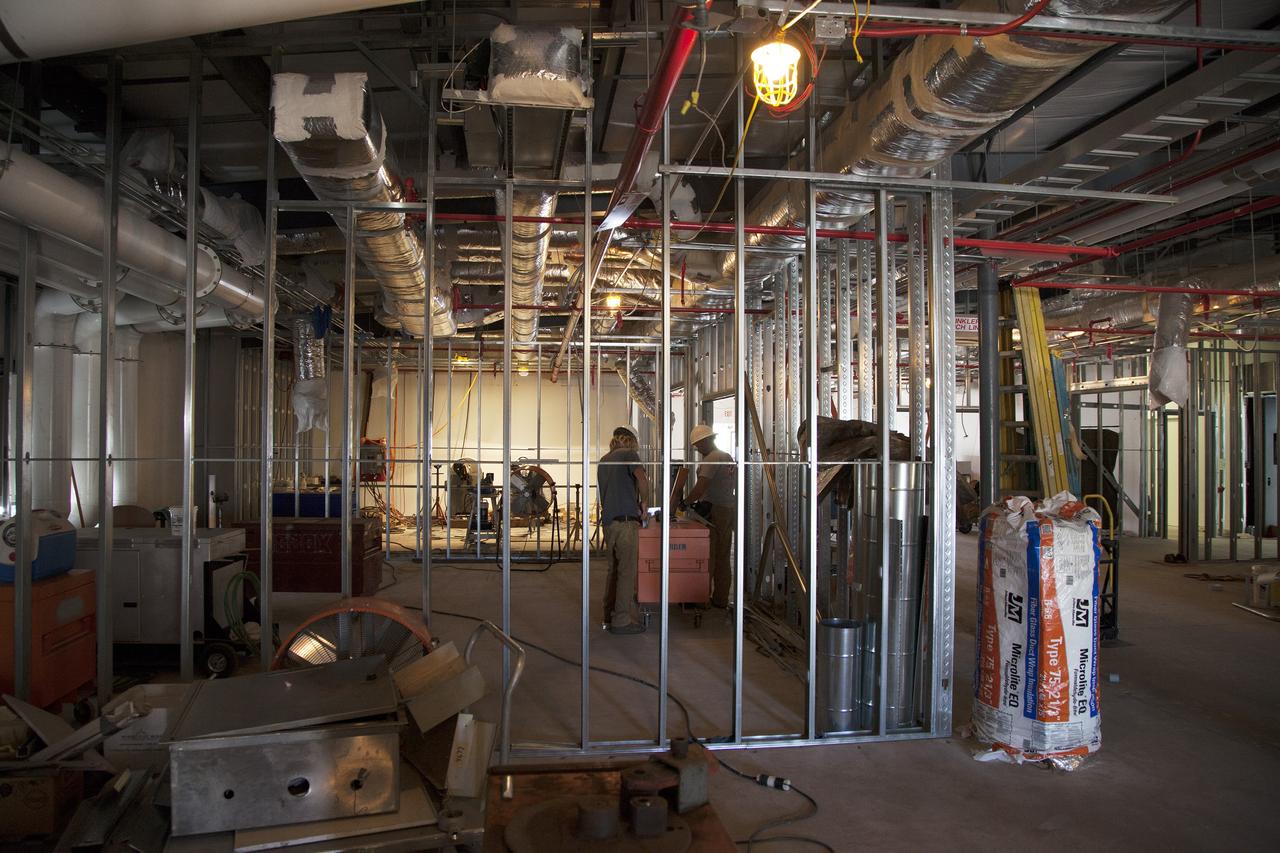 CAPE CANAVERAL, Fla. – Modifications continue on the Multi-Payload Processing Facility, or MPPF, at NASA's Kennedy Space Center in Florida. Inside the MPPF annex building, construction workers are converting the building to a ground support equipment storage area and work area. The pipes overhead are part of the Environmental Control System.    Kennedy's Center Operations Directorate is overseeing upgrades to the MPPF for the Ground Systems Development and Operations Program. The extensive upgrades and modernizations will support processing of Orion spacecraft for NASA's exploration missions. The 19,647-square-foot building, originally constructed in 1995, primarily will be used for Orion hypergolic fueling, ammonia servicing and high-pressure gas servicing and checkout before being transported to the Vehicle Assembly Building for integration with the Space Launch System. Photo credit: NASA/Daniel Casper