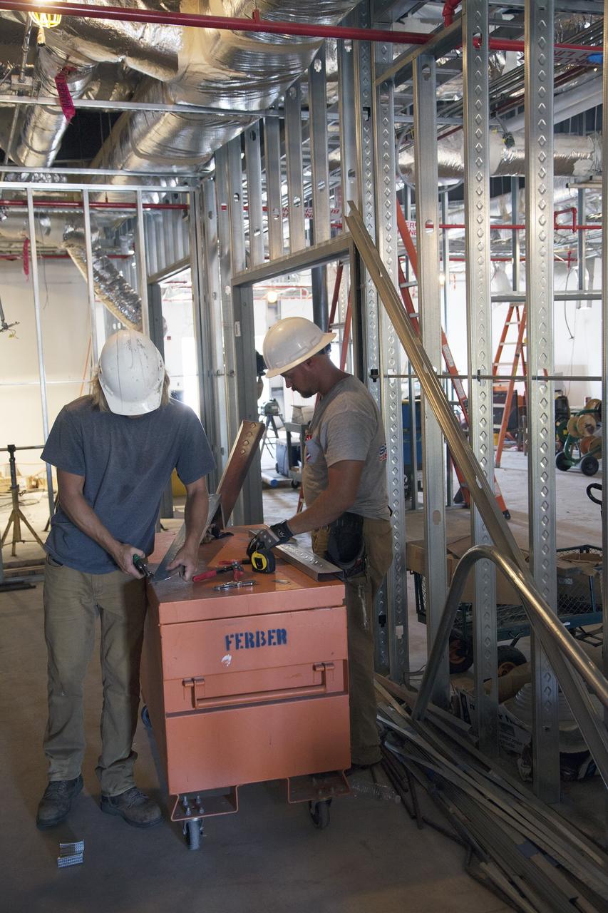 CAPE CANAVERAL, Fla. – Modifications continue on the Multi-Payload Processing Facility, or MPPF, at NASA's Kennedy Space Center in Florida. Inside the MPPF annex building, construction workers are converting the building to a ground support equipment storage area and work area. The pipes overhead are part of the Environmental Control System.    Kennedy's Center Operations Directorate is overseeing upgrades to the MPPF for the Ground Systems Development and Operations Program. The extensive upgrades and modernizations will support processing of Orion spacecraft for NASA's exploration missions. The 19,647-square-foot building, originally constructed in 1995, primarily will be used for Orion hypergolic fueling, ammonia servicing and high-pressure gas servicing and checkout before being transported to the Vehicle Assembly Building for integration with the Space Launch System. Photo credit: NASA/Daniel Casper