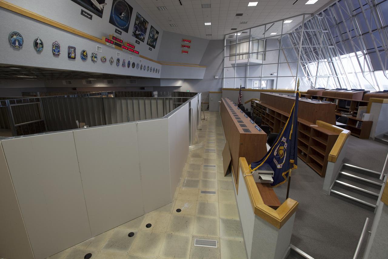 CAPE CANAVERAL, Fla. – Construction workers have installed the framing and some of the inner walls inside Firing Room 4 in the Launch Control Center at NASA's Kennedy Space Center in Florida. Three rows of upper level management consoles remain. The Ground Systems Development and Operations Program is overseeing efforts to create a new firing room based on a multi-user concept.    The design of Firing Room 4 will incorporate five control room areas that are flexible to meet current and future NASA and commercial user requirements. The equipment and most of the consoles from Firing Room 4 were moved to Firing Room 2 for possible future reuse. Photo credit: NASA/Dimitri Gerondidakis