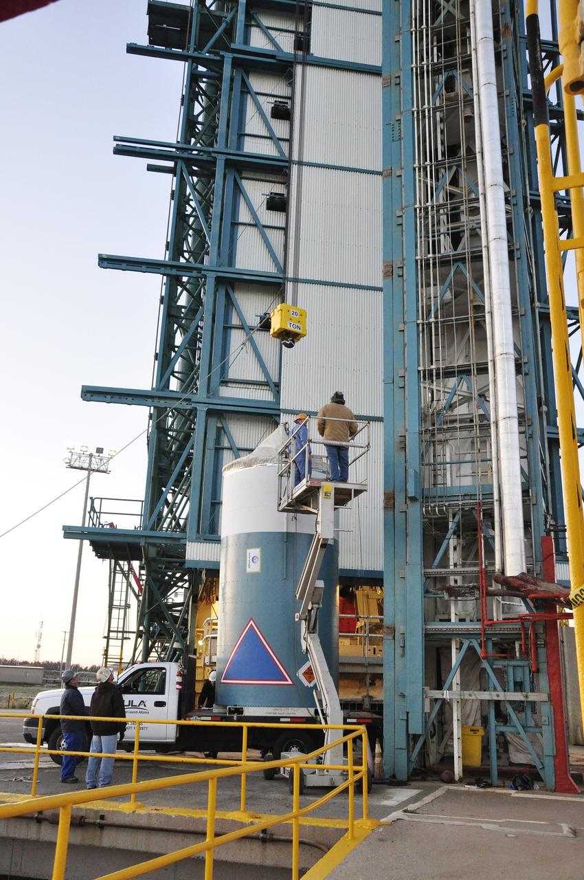 VANDENBERG AIR FORCE BASE, Calif. – A worker prepares to connect a crane to the interstage adapter, or ISA, for NASA's Orbiting Carbon Observatory-2 mission, or OCO-2, at the mobile service tower at Space Launch Complex 2 on Vandenberg Air Force Base in California.     OCO-2 is scheduled to launch into a polar Earth orbit aboard a United Launch Alliance Delta II 7320-10C rocket in July. The ISA is the interface between the Delta II first and second stages. The second stage engine fits within the ISA. Once in orbit, OCO-2 will collect precise global measurements of carbon dioxide in the Earth's atmosphere and provide scientists with a better idea of the chemical compound's impacts on climate change. Scientists will analyze this data to improve our understanding of the natural processes and human activities that regulate the abundance and distribution of this important atmospheric gas. To learn more about OCO-2, visit http://oco.jpl.nasa.gov.  Photo credit: NASA/Randy Beaudoin