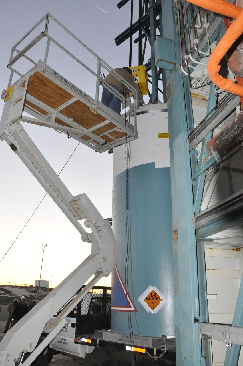 VANDENBERG AIR FORCE BASE, Calif. – A worker connects a crane to the interstage adapter, or ISA, for NASA's Orbiting Carbon Observatory-2 mission, or OCO-2, at the mobile service tower at Space Launch Complex 2 on Vandenberg Air Force Base in California.    OCO-2 is scheduled to launch into a polar Earth orbit aboard a United Launch Alliance Delta II 7320-10C rocket in July. The ISA is the interface between the Delta II first and second stages. The second stage engine fits within the ISA. Once in orbit, OCO-2 will collect precise global measurements of carbon dioxide in the Earth's atmosphere and provide scientists with a better idea of the chemical compound's impacts on climate change. Scientists will analyze this data to improve our understanding of the natural processes and human activities that regulate the abundance and distribution of this important atmospheric gas. To learn more about OCO-2, visit http://oco.jpl.nasa.gov.  Photo credit: NASA/Randy Beaudoin