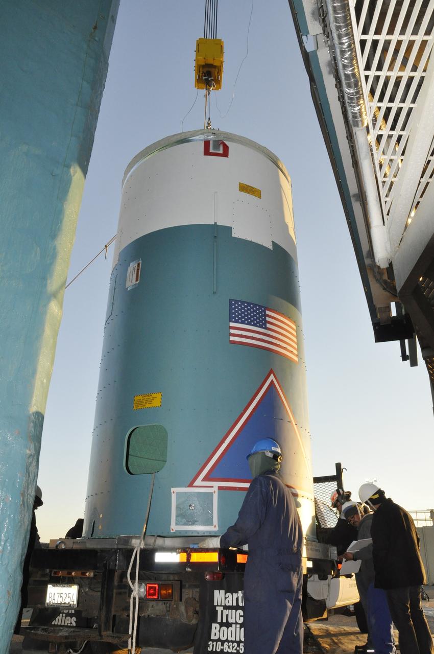 VANDENBERG AIR FORCE BASE, Calif. – Workers prepare to lift the interstage adapter, or ISA, for NASA's Orbiting Carbon Observatory-2 mission, or OCO-2, by crane into the mobile service tower at Space Launch Complex 2 on Vandenberg Air Force Base in California.    OCO-2 is scheduled to launch into a polar Earth orbit aboard a United Launch Alliance Delta II 7320-10C rocket in July. The ISA is the interface between the Delta II first and second stages. The second stage engine fits within the ISA. Once in orbit, OCO-2 will collect precise global measurements of carbon dioxide in the Earth's atmosphere and provide scientists with a better idea of the chemical compound's impacts on climate change. Scientists will analyze this data to improve our understanding of the natural processes and human activities that regulate the abundance and distribution of this important atmospheric gas. To learn more about OCO-2, visit http://oco.jpl.nasa.gov.  Photo credit: NASA/Randy Beaudoin