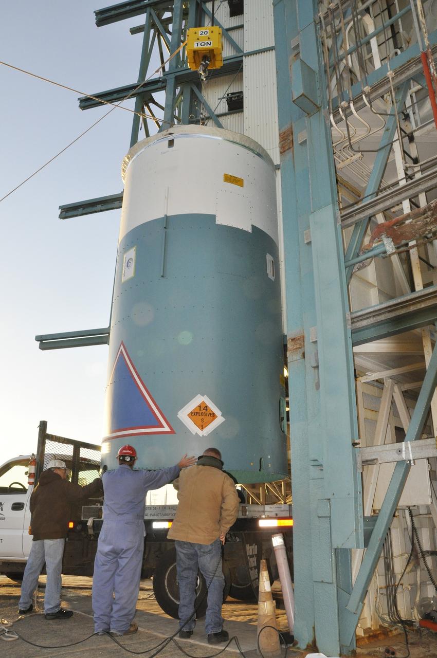 VANDENBERG AIR FORCE BASE, Calif. – Workers steady the interstage adapter, or ISA, for NASA's Orbiting Carbon Observatory-2 mission, or OCO-2, as a crane lifts it from its transporter next to the mobile service tower at Space Launch Complex 2 on Vandenberg Air Force Base in California.    OCO-2 is scheduled to launch into a polar Earth orbit aboard a United Launch Alliance Delta II 7320-10C rocket in July. The ISA is the interface between the Delta II first and second stages. The second stage engine fits within the ISA. Once in orbit, OCO-2 will collect precise global measurements of carbon dioxide in the Earth's atmosphere and provide scientists with a better idea of the chemical compound's impacts on climate change. Scientists will analyze this data to improve our understanding of the natural processes and human activities that regulate the abundance and distribution of this important atmospheric gas. To learn more about OCO-2, visit http://oco.jpl.nasa.gov.  Photo credit: NASA/Randy Beaudoin