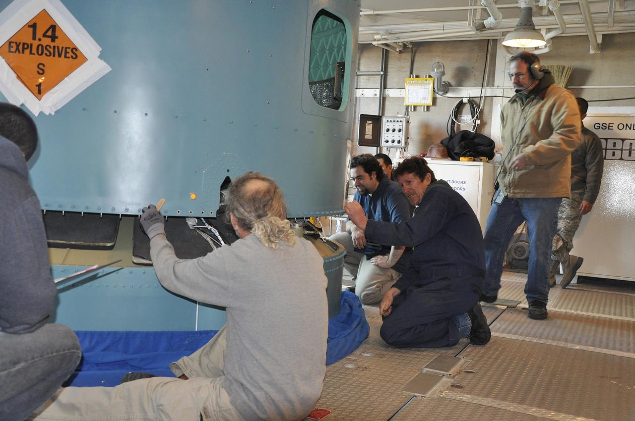 VANDENBERG AIR FORCE BASE, Calif. – Workers connect the interstage adapter, or ISA, for NASA's Orbiting Carbon Observatory-2 mission, or OCO-2, to the Delta II first stage in the environmental enclosure, or clean room, near the top of the mobile service tower at Space Launch Complex 2 on Vandenberg Air Force Base in California.    OCO-2 is scheduled to launch into a polar Earth orbit aboard a United Launch Alliance Delta II 7320-10C rocket in July. The ISA is the interface between the Delta II first and second stages. The second stage engine fits within the ISA. Once in orbit, OCO-2 will collect precise global measurements of carbon dioxide in the Earth's atmosphere and provide scientists with a better idea of the chemical compound's impacts on climate change. Scientists will analyze this data to improve our understanding of the natural processes and human activities that regulate the abundance and distribution of this important atmospheric gas. To learn more about OCO-2, visit http://oco.jpl.nasa.gov.  Photo credit: NASA/Randy Beaudoin