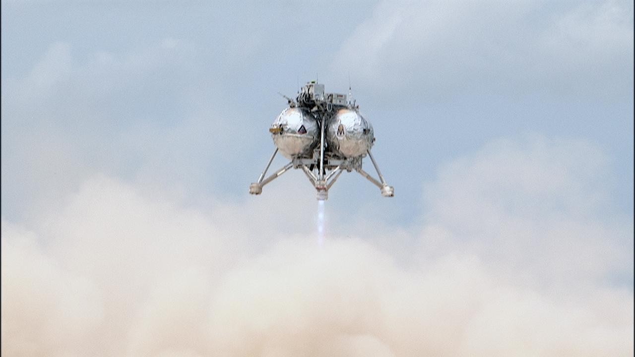 CAPE CANAVERAL, Fla. – NASA's Project Morpheus prototype lander begins to descend toward the autonomous landing and hazard avoidance technology, or ALHAT, field after lifting off on a free-flight test from a new launch pad at the north end of the Shuttle Landing Facility at NASA's Kennedy Space Center in Florida. The 98-second test began at 1:57 p.m. EDT with the Morpheus lander launching from the ground over a flame trench and ascending more than 800 feet at a peak speed of 36 mph. The vehicle, with its recently installed ALHAT sensors, surveyed the hazard field to determine safe landing sites. Morpheus then flew forward and downward covering approximately 1300 feet while performing a 78-foot divert to simulate a hazard avoidance maneuver. The lander descended and landed on a dedicated pad inside the ALHAT hazard field. Project Morpheus tests NASA’s ALHAT and an engine that runs on liquid oxygen and methane, which are green propellants. These new capabilities could be used in future efforts to deliver cargo to planetary surfaces.    The landing facility provides the lander with the kind of field necessary for realistic testing, complete with rocks, craters and hazards to avoid. Morpheus’ ALHAT payload allows it to navigate to clear landing sites amidst rocks, craters and other hazards during its descent. Project Morpheus is being managed under the Advanced Exploration Systems, or AES, Division in NASA’s Human Exploration and Operations Mission Directorate. The efforts in AES pioneer new approaches for rapidly developing prototype systems, demonstrating key capabilities and validating operational concepts for future human missions beyond Earth orbit. For more information on Project Morpheus, visit http://morpheuslander.jsc.nasa.gov/.  Photo credit: NASA/Frankie Martin