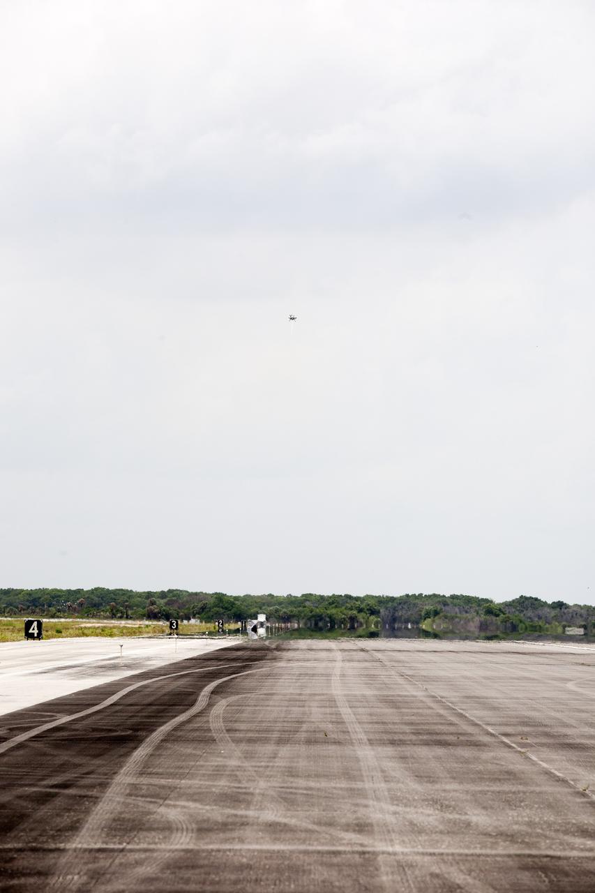 CAPE CANAVERAL, Fla. – NASA's Project Morpheus prototype lander soars high after lifting off on a free-flight test from a new launch pad at the north end of the Shuttle Landing Facility at NASA's Kennedy Space Center in Florida. The 98-second test began at 1:57 p.m. EDT with the Morpheus lander launching from the ground over a flame trench and ascending more than 800 feet at a peak speed of 36 mph. The vehicle, with its recently installed autonomous landing and hazard avoidance technology, or ALHAT, sensors surveyed the hazard field to determine safe landing sites. Morpheus then flew forward and downward covering approximately 1300 feet while performing a 78-foot divert to simulate a hazard avoidance maneuver. The lander descended and landed on a dedicated pad inside the ALHAT hazard field. Project Morpheus tests NASA’s ALHAT and an engine that runs on liquid oxygen and methane, which are green propellants. These new capabilities could be used in future efforts to deliver cargo to planetary surfaces.     The landing facility provides the lander with the kind of field necessary for realistic testing, complete with rocks, craters and hazards to avoid. Morpheus’ ALHAT payload allows it to navigate to clear landing sites amidst rocks, craters and other hazards during its descent. Project Morpheus is being managed under the Advanced Exploration Systems, or AES, Division in NASA’s Human Exploration and Operations Mission Directorate. The efforts in AES pioneer new approaches for rapidly developing prototype systems, demonstrating key capabilities and validating operational concepts for future human missions beyond Earth orbit. For more information on Project Morpheus, visit http://morpheuslander.jsc.nasa.gov/.  Photo credit: NASA/Kim Shiflett