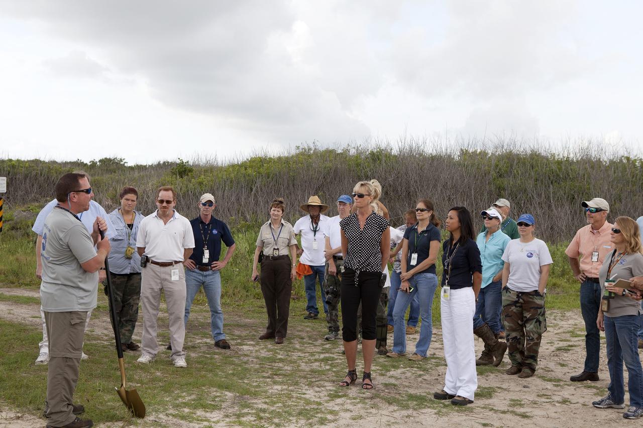 CAPE CANAVERAL, Fla. -- At the Kennedy Space Center in Florida, Don Dankert, a biological scientist in the NASA Environmental Management Branch of Center Operations, far left, speaks to guests during ceremonies to commemorate the completion of a six-month effort to restore 1.2 mile stretch of shoreline near Launch Pads 39A and B. To help prevent erosion, 180,000 shrubs, including grasses, sunflowers, vines, sea grapes and palmettos also were planted on the new dunes.        Constant pounding from tropical storms, such as Hurricane Sandy in October of 2012, other weather systems and higher than usual tides, destroyed sand dunes protecting infrastructure at the spaceport. Photo credit: NASA/Dan Casper