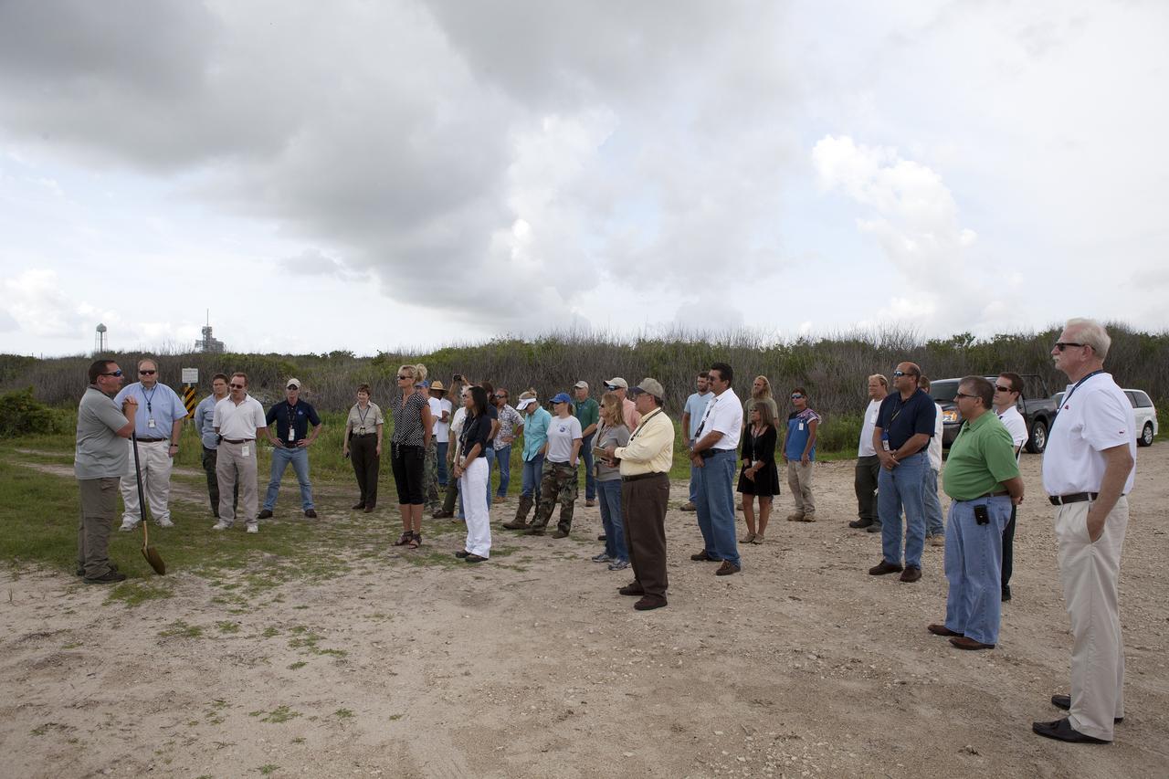 CAPE CANAVERAL, Fla. -- At the Kennedy Space Center in Florida, Don Dankert, a biological scientist in the NASA Environmental Management Branch of Center Operations, far left, speaks to guests during ceremonies to commemorate the completion of a six-month effort to restore 1.2 mile stretch of shoreline near Launch Pads 39A and B. To help prevent erosion, 180,000 shrubs, including grasses, sunflowers, vines, sea grapes and palmettos also were planted on the new dunes.      Constant pounding from tropical storms, such as Hurricane Sandy in October of 2012, other weather systems and higher than usual tides, destroyed sand dunes protecting infrastructure at the spaceport. Photo credit: NASA/Dan Casper
