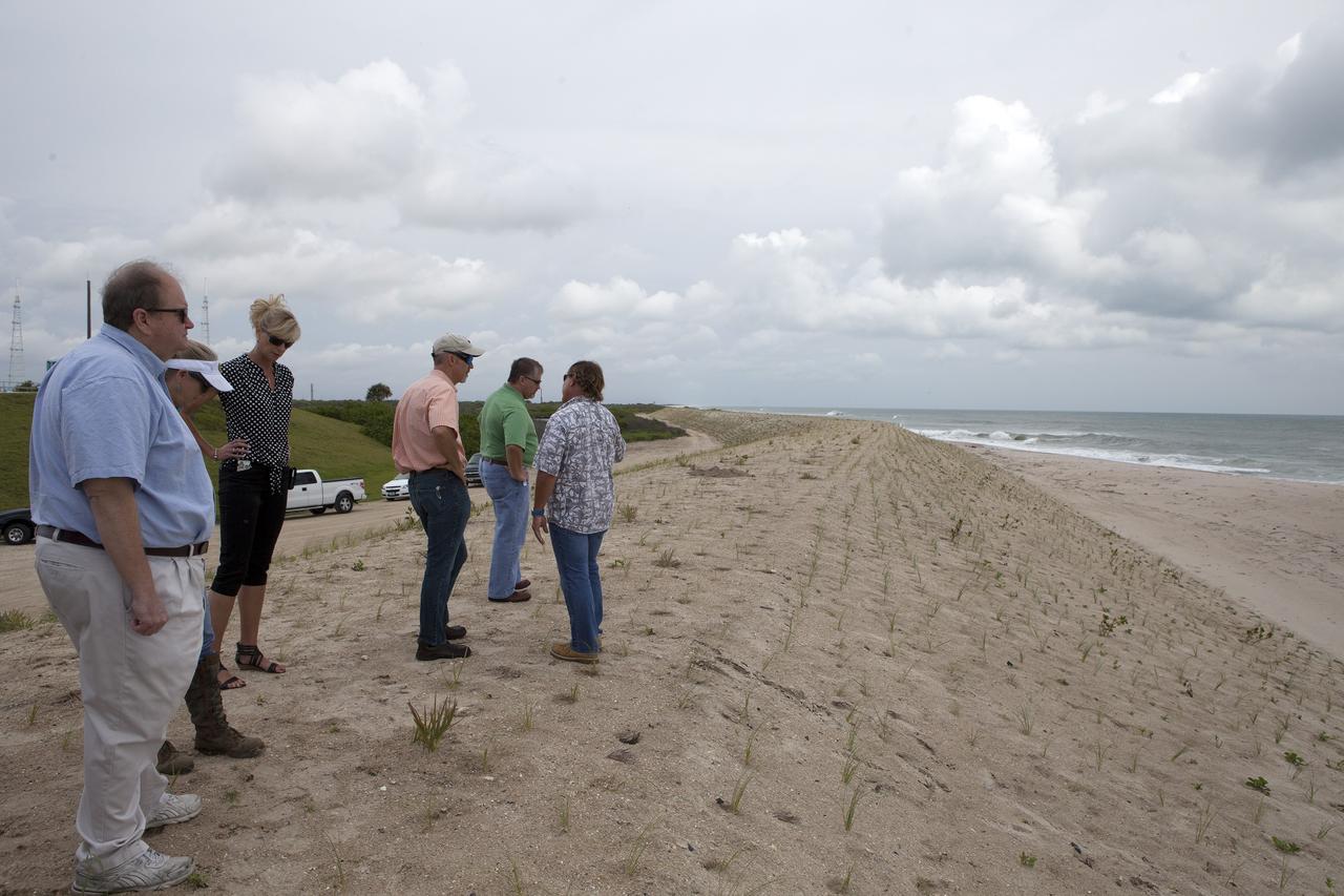CAPE CANAVERAL, Fla. -- At the Kennedy Space Center in Florida, Burton Summerfield, senior advisor for Institutional Management in the office of the associate director of Kennedy, far left, and others survey restored sand dunes along a 1.2-mile stretch of shoreline near Launch Pads 39A and B.      Constant pounding from tropical storms, such as Hurricane Sandy in October of 2012, other weather systems and higher than usual tides, destroyed sand dunes protecting infrastructure at the spaceport. Photo credit: NASA/Dan Casper