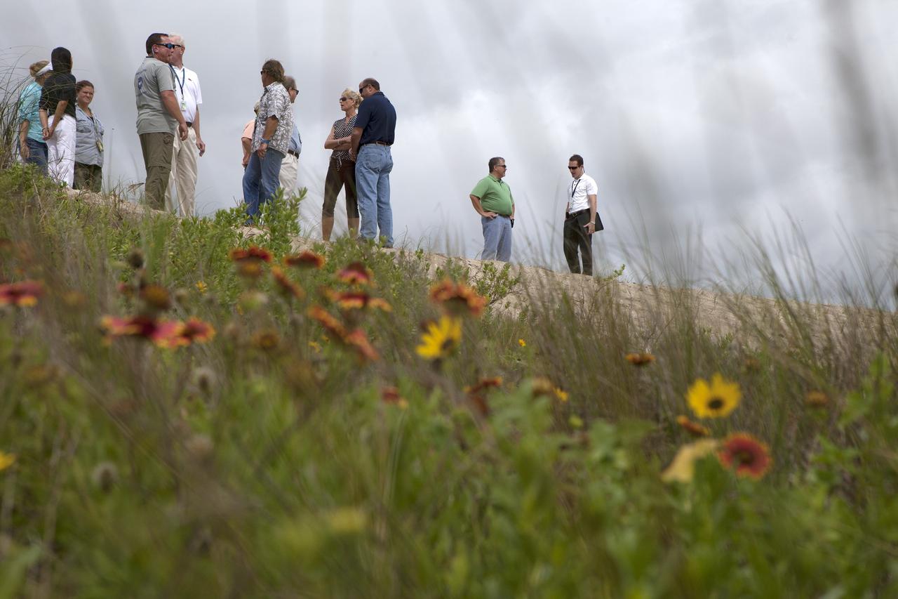 CAPE CANAVERAL, Fla. -- At the Kennedy Space Center in Florida, guests survey restored sand dunes along a 1.2-mile stretch of shoreline near Launch Pads 39A and B.      Constant pounding from tropical storms, such as Hurricane Sandy in October of 2012, other weather systems and higher than usual tides, destroyed sand dunes protecting infrastructure at the spaceport. Photo credit: NASA/Dan Casper