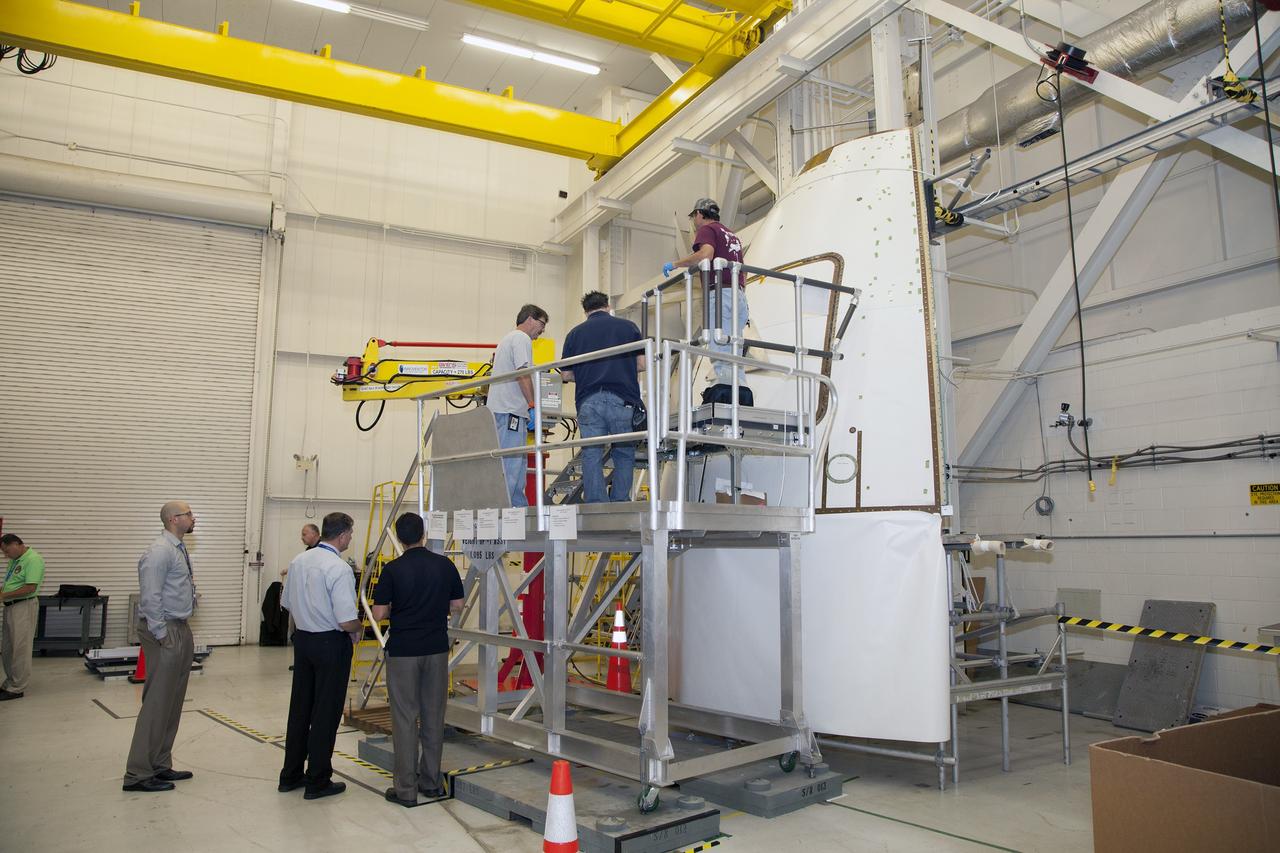 CAPE CANAVERAL, Fla. – Inside the Vehicle Assembly Building at NASA’s Kennedy Space Center in Florida, engineers and technicians prepare the ground test article Launch Abort System, or LAS, ogive panel and an Orion crew module simulator for a GIZMO demonstration test. The GIZMO is a pneumatically-balanced manipulator that will be used for installation of the crew module and LAS flight hatches for the uncrewed Exploration Flight Test-1 and Exploration Mission-1. The Ground Systems Development and Operations Program is running the test to demonstrate that the GIZMO can meet the reach and handling requirements for the task.    Orion is the exploration spacecraft designed to carry astronauts to destinations not yet explored by humans, including an asteroid and Mars. It will have emergency abort capability, sustain the crew during space travel and provide safe re-entry from deep space return velocities. The first unpiloted test flight of the Orion is scheduled to launch later this year atop a Delta IV rocket and in 2017 on NASA’s Space Launch System rocket. For more information, visit http://www.nasa.gov/orion. Photo credit: NASA/Daniel Casper