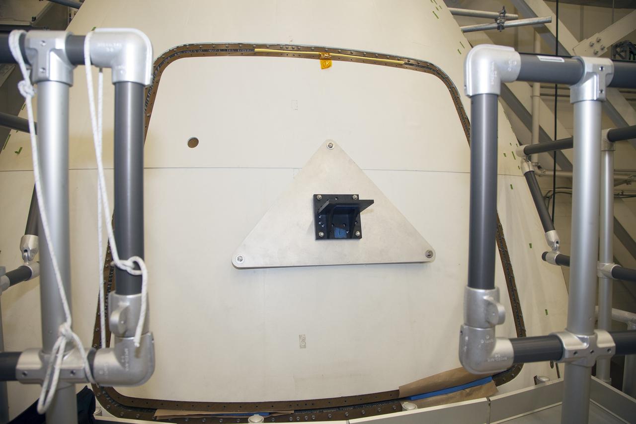 CAPE CANAVERAL, Fla. – Inside the Vehicle Assembly Building at NASA’s Kennedy Space Center in Florida, engineers and technicians prepare the ground test article Launch Abort System, or LAS, ogive panel and an Orion crew module simulator for a GIZMO demonstration test. The GIZMO is a pneumatically-balanced manipulator that will be used for installation of the crew module and LAS flight hatches for the uncrewed Exploration Flight Test-1 and Exploration Mission-1. The Ground Systems Development and Operations Program is running the test to demonstrate that the GIZMO can meet the reach and handling requirements for the task. Orion is the exploration spacecraft designed to carry astronauts to destinations not yet explored by humans, including an asteroid and Mars. It will have emergency abort capability, sustain the crew during space travel and provide safe re-entry from deep space return velocities. The first unpiloted test flight of the Orion is scheduled to launch later this year atop a Delta IV rocket and in 2017 on NASA’s Space Launch System rocket. For more information, visit http://www.nasa.gov/orion. Photo credit: NASA/Daniel Casper