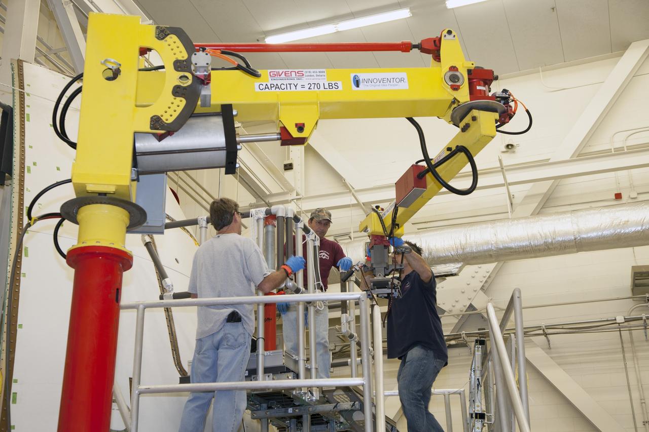 CAPE CANAVERAL, Fla. – Inside the Vehicle Assembly Building at NASA’s Kennedy Space Center in Florida, engineers and technicians have prepared the ground test article Launch Abort System, or LAS, ogive panel and an Orion crew module simulator for a GIZMO demonstration test. A technician moves the GIZMO, a pneumatically-balanced manipulator that will be used for installation of the crew module and LAS flight hatches for the uncrewed Exploration Flight Test-1 and Exploration Mission-1, toward the mockup. The Ground Systems Development and Operations Program is running the test to demonstrate that the GIZMO can meet the reach and handling requirements for the task.     Orion is the exploration spacecraft designed to carry astronauts to destinations not yet explored by humans, including an asteroid and Mars. It will have emergency abort capability, sustain the crew during space travel and provide safe re-entry from deep space return velocities. The first unpiloted test flight of the Orion is scheduled to launch later this year atop a Delta IV rocket and in 2017 on NASA’s Space Launch System rocket. For more information, visit http://www.nasa.gov/orion. Photo credit: NASA/Daniel Casper