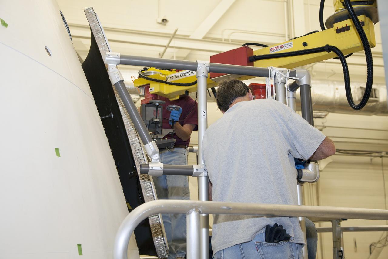 CAPE CANAVERAL, Fla. – Inside the Vehicle Assembly Building at NASA’s Kennedy Space Center in Florida, engineers and technicians are performing a GIZMO demonstration test on the ground test article Launch Abort System, or LAS, ogive panel and an Orion crew module simulator. Technicians attach the GIZMO, a pneumatically-balanced manipulator that will be used for installation of the hatches on the crew module and LAS for the uncrewed Exploration Flight Test-1 and Exploration Mission-1, onto the mockup. The Ground Systems Development and Operations Program is running the test to demonstrate that the GIZMO can meet the reach and handling requirements for the task.    Orion is the exploration spacecraft designed to carry astronauts to destinations not yet explored by humans, including an asteroid and Mars. It will have emergency abort capability, sustain the crew during space travel and provide safe re-entry from deep space return velocities. The first unpiloted test flight of the Orion is scheduled to launch later this year atop a Delta IV rocket and in 2017 on NASA’s Space Launch System rocket. For more information, visit http://www.nasa.gov/orion. Photo credit: NASA/Daniel Casper