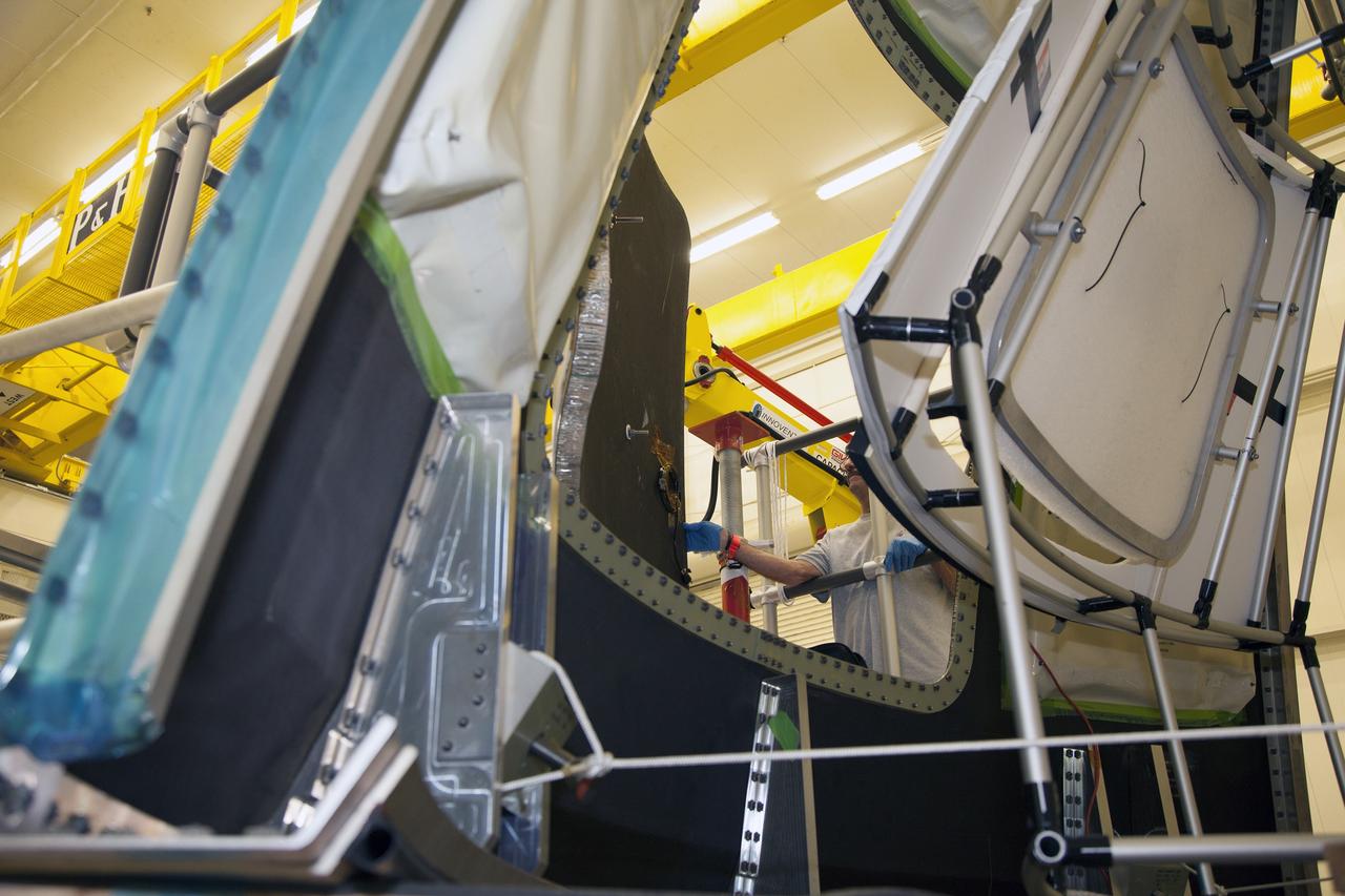 CAPE CANAVERAL, Fla. – Inside the Vehicle Assembly Building at NASA’s Kennedy Space Center in Florida, engineers and technicians are performing a GIZMO demonstration test on the ground test article Launch Abort System, or LAS, ogive panel and an Orion crew module simulator. Technicians attached the GIZMO to remove the outer ogive panel hatch on the Orion crew module simulator. The GIZMO is a pneumatically-balanced manipulator that will be used for installation of the hatches on the crew module and LAS for the uncrewed Exploration Flight Test-1 and Exploration Mission-1. The Ground Systems Development and Operations Program is running the test to demonstrate that the GIZMO can meet the reach and handling requirements for the task.    Orion is the exploration spacecraft designed to carry astronauts to destinations not yet explored by humans, including an asteroid and Mars. It will have emergency abort capability, sustain the crew during space travel and provide safe re-entry from deep space return velocities. The first unpiloted test flight of the Orion is scheduled to launch later this year atop a Delta IV rocket and in 2017 on NASA’s Space Launch System rocket. For more information, visit http://www.nasa.gov/orion. Photo credit: NASA/Daniel Casper