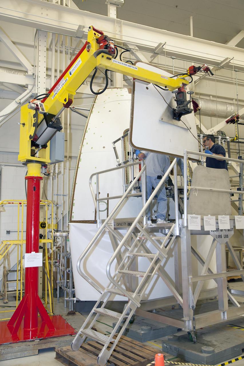 CAPE CANAVERAL, Fla. – Inside the Vehicle Assembly Building at NASA’s Kennedy Space Center in Florida, engineers and technicians are performing a GIZMO demonstration test on the ground test article Launch Abort System, or LAS, ogive panel and an Orion crew module simulator. Technicians attach the GIZMO, a pneumatically-balanced manipulator that will be used for installation of the hatches on the crew module and LAS for the uncrewed Exploration Flight Test-1 and Exploration Mission-1, onto the ogive panel mockup hatch. The Ground Systems Development and Operations Program is running the test to demonstrate that the GIZMO can meet the reach and handling requirements for the task.    Orion is the exploration spacecraft designed to carry astronauts to destinations not yet explored by humans, including an asteroid and Mars. It will have emergency abort capability, sustain the crew during space travel and provide safe re-entry from deep space return velocities. The first unpiloted test flight of the Orion is scheduled to launch later this year atop a Delta IV rocket and in 2017 on NASA’s Space Launch System rocket. For more information, visit http://www.nasa.gov/orion. Photo credit: NASA/Daniel Casper