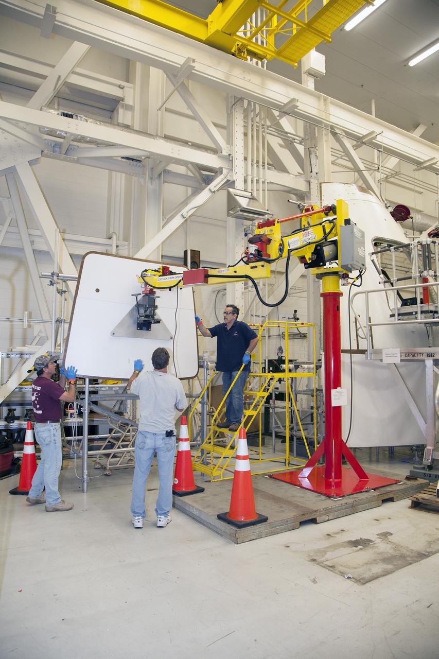 CAPE CANAVERAL, Fla. – Inside the Vehicle Assembly Building at NASA’s Kennedy Space Center in Florida, engineers and technicians are performing a GIZMO demonstration test on the ground test article Launch Abort System, or LAS, ogive panel and an Orion crew module simulator. Technicians practice lining up the GIZMO, a pneumatically-balanced manipulator that will be used for installation of the hatches on the crew module and LAS for the uncrewed Exploration Flight Test-1 and Exploration Mission-1, on the ogive panel mockup hatch. The Ground Systems Development and Operations Program is running the test to demonstrate that the GIZMO can meet the reach and handling requirements for the task.    Orion is the exploration spacecraft designed to carry astronauts to destinations not yet explored by humans, including an asteroid and Mars. It will have emergency abort capability, sustain the crew during space travel and provide safe re-entry from deep space return velocities. The first unpiloted test flight of the Orion is scheduled to launch later this year atop a Delta IV rocket and in 2017 on NASA’s Space Launch System rocket. For more information, visit http://www.nasa.gov/orion. Photo credit: NASA/Daniel Casper