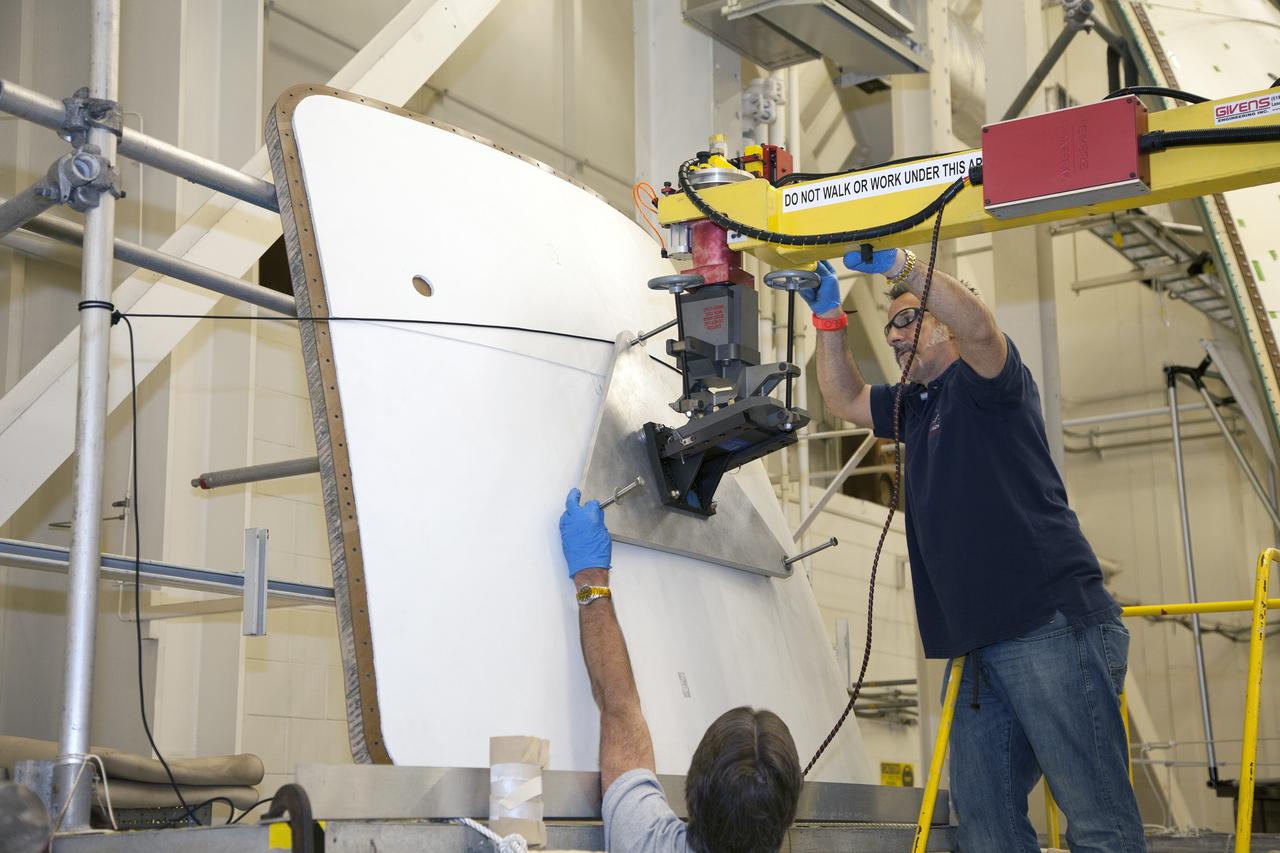CAPE CANAVERAL, Fla. – Inside the Vehicle Assembly Building at NASA’s Kennedy Space Center in Florida, engineers and technicians are performing a GIZMO demonstration test on the ground test article Launch Abort System, or LAS, ogive panel and an Orion crew module simulator. Technicians practice lining up the GIZMO, a pneumatically-balanced manipulator that will be used for installation of the hatches on the crew module and LAS for the uncrewed Exploration Flight Test-1 and Exploration Mission-1, on the ogive panel mockup hatch. The Ground Systems Development and Operations Program is running the test to demonstrate that the GIZMO can meet the reach and handling requirements for the task.    Orion is the exploration spacecraft designed to carry astronauts to destinations not yet explored by humans, including an asteroid and Mars. It will have emergency abort capability, sustain the crew during space travel and provide safe re-entry from deep space return velocities. The first unpiloted test flight of the Orion is scheduled to launch later this year atop a Delta IV rocket and in 2017 on NASA’s Space Launch System rocket. For more information, visit http://www.nasa.gov/orion. Photo credit: NASA/Daniel Casper