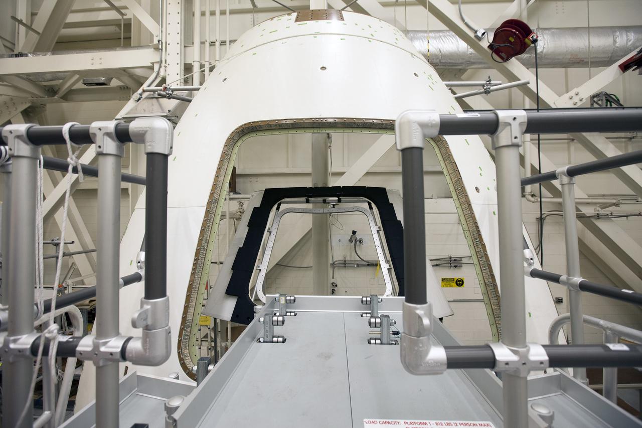 CAPE CANAVERAL, Fla. – Inside the Vehicle Assembly Building at NASA’s Kennedy Space Center in Florida, a GIZMO demonstration test is being performed on the ground test article Launch Abort System, or LAS, ogive panel and an Orion crew module simulator. An access platform has been added leading up to the mockup of the crew module. The inner hatch has been removed. The GIZMO is a pneumatically-balanced manipulator that will be used for installation of the hatches on the crew module and LAS for the uncrewed Exploration Flight Test-1 and Exploration Mission-1. The Ground Systems Development and Operations Program is running the test to demonstrate that the GIZMO can meet the reach and handling requirements for the task.    Orion is the exploration spacecraft designed to carry astronauts to destinations not yet explored by humans, including an asteroid and Mars. It will have emergency abort capability, sustain the crew during space travel and provide safe re-entry from deep space return velocities. The first unpiloted test flight of the Orion is scheduled to launch later this year atop a Delta IV rocket and in 2017 on NASA’s Space Launch System rocket. For more information, visit http://www.nasa.gov/orion. Photo credit: NASA/Daniel Casper