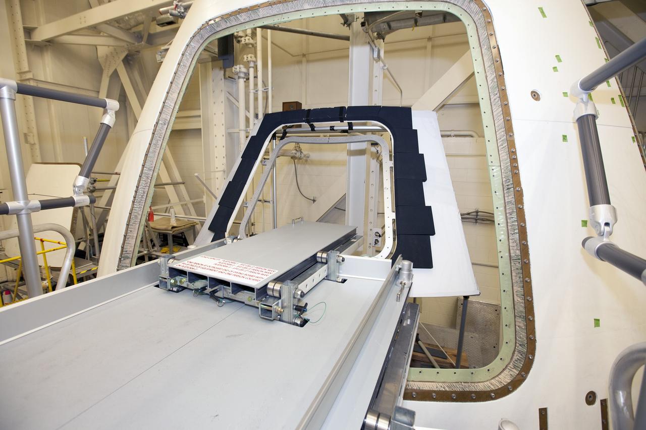 CAPE CANAVERAL, Fla. – Inside the Vehicle Assembly Building at NASA’s Kennedy Space Center in Florida, a GIZMO demonstration test is being performed on the ground test article Launch Abort System, or LAS, ogive panel and an Orion crew module simulator. An access platform and diving board have been added leading up to the mockup of the crew module hatch. The inner hatch has been removed The GIZMO is a pneumatically-balanced manipulator that will be used for installation of the hatches on the crew module and LAS for the uncrewed Exploration Flight Test-1 and Exploration Mission-1. The Ground Systems Development and Operations Program is running the test to demonstrate that the GIZMO can meet the reach and handling requirements for the task.    Orion is the exploration spacecraft designed to carry astronauts to destinations not yet explored by humans, including an asteroid and Mars. It will have emergency abort capability, sustain the crew during space travel and provide safe re-entry from deep space return velocities. The first unpiloted test flight of the Orion is scheduled to launch later this year atop a Delta IV rocket and in 2017 on NASA’s Space Launch System rocket. For more information, visit http://www.nasa.gov/orion. Photo credit: NASA/Daniel Casper