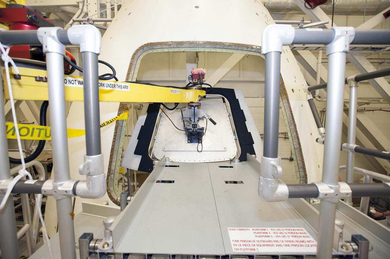 CAPE CANAVERAL, Fla. – Inside the Vehicle Assembly Building at NASA’s Kennedy Space Center in Florida, a GIZMO demonstration test is being performed on the ground test article Launch Abort System, or LAS, ogive panel and an Orion crew module simulator. An access platform has been added leading up to the mockup of the crew module. Technicians used the GIZMO, a pneumatically-balanced manipulator that will be used for the uncrewed Exploration Flight Test-1 and Exploration Mission-1, to install the mockup of the crew module inner hatch. The Ground Systems Development and Operations Program is running the test to demonstrate that the GIZMO can meet the reach and handling requirements for the task.    Orion is the exploration spacecraft designed to carry astronauts to destinations not yet explored by humans, including an asteroid and Mars. It will have emergency abort capability, sustain the crew during space travel and provide safe re-entry from deep space return velocities. The first unpiloted test flight of the Orion is scheduled to launch later this year atop a Delta IV rocket and in 2017 on NASA’s Space Launch System rocket. For more information, visit http://www.nasa.gov/orion. Photo credit: NASA/Daniel Casper