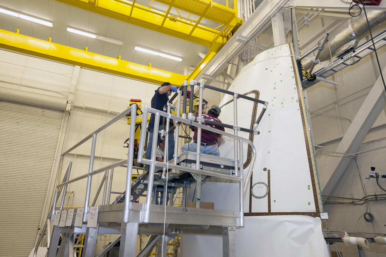 CAPE CANAVERAL, Fla. – Inside the Vehicle Assembly Building at NASA’s Kennedy Space Center in Florida, a GIZMO demonstration test is being performed on the ground test article Launch Abort System, or LAS, ogive panel and an Orion crew module simulator. Technicians installed the mockup of the ogive hatch using the GIZMO, a pneumatically-balanced manipulator that will be used for the uncrewed Exploration Flight Test-1 and Exploration Mission-1. The Ground Systems Development and Operations Program is running the test to demonstrate that the GIZMO can meet the reach and handling requirements for the task.    Orion is the exploration spacecraft designed to carry astronauts to destinations not yet explored by humans, including an asteroid and Mars. It will have emergency abort capability, sustain the crew during space travel and provide safe re-entry from deep space return velocities. The first unpiloted test flight of the Orion is scheduled to launch later this year atop a Delta IV rocket and in 2017 on NASA’s Space Launch System rocket. For more information, visit http://www.nasa.gov/orion. Photo credit: NASA/Daniel Casper