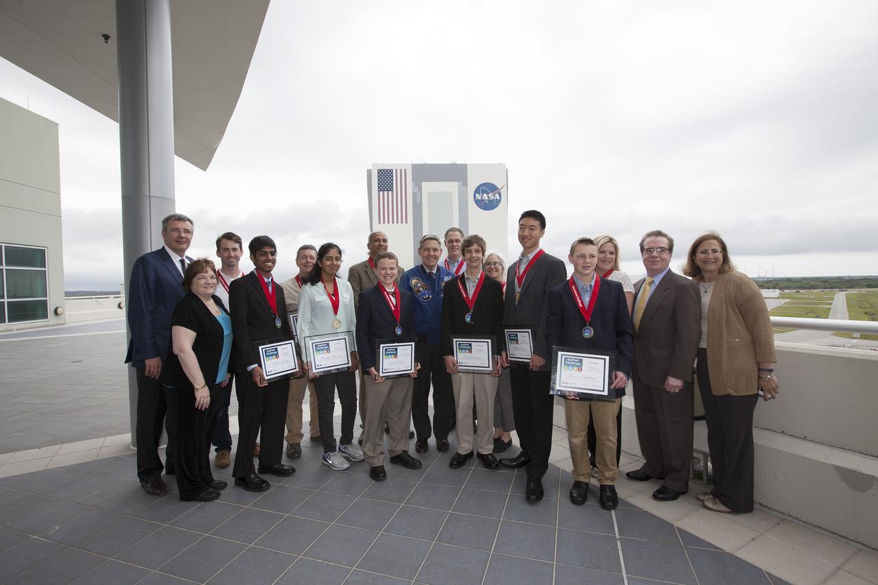CAPE CANAVERAL, Fla. – The winning students and their teachers of the 2014 DuPont Challenge Science Essay Competition show off their awards after a ceremony at the Operations and Support Building II at Kennedy Space Center in Florida. Center Director Bob Cabana is in the middle. The challenge, now in its 28th year, reaches out to students from grades seven through 12 from all 50 states and Canada. More than 200,000 students entered the competition. The DuPont Challenge aims to inspire students to excel and achieve in scientific writing and pursue careers in science, technology, engineering and mathematics STEM. The challenge honors space shuttle Challenger's STS-51L crew members who gave their lives while furthering the cause of exploration and discovery. For more information on the challenge, go to http://thechallenge.dupont.com/sponsors/nasa.php. Photo credit: NASA/Kim Shiflett