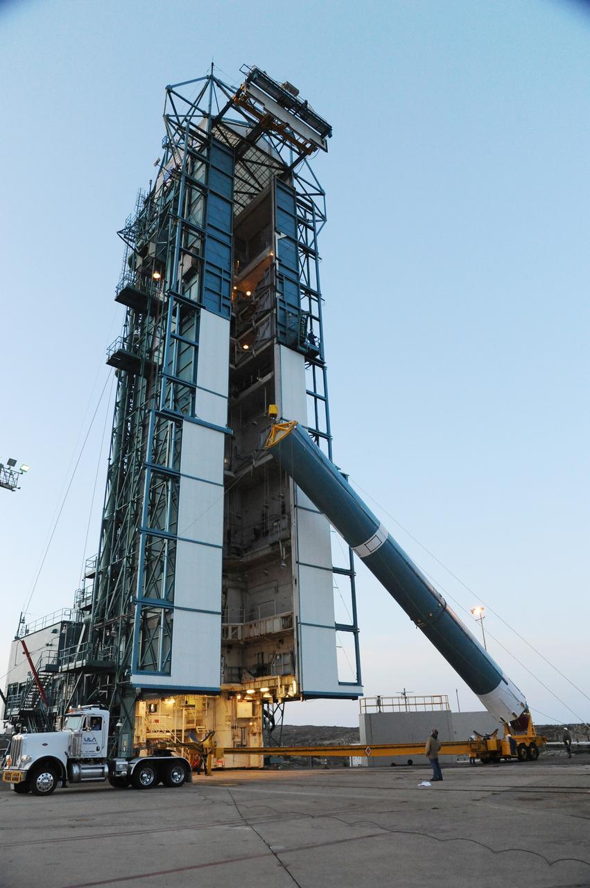 VANDENBERG AIR FORCE BASE, Calif. – The United Launch Alliance Delta II rocket for NASA's Orbiting Carbon Observatory-2 mission, or OCO-2, is lifted into a vertical position beside the mobile service tower at Space Launch Complex 2 on Vandenberg Air Force Base in California.    Launch is scheduled for July 1, 2014.  The observatory will collect precise global measurements of carbon dioxide in the Earth's atmosphere and provide scientists with a better idea of the chemical compound's impacts on climate change. Scientists will analyze this data to improve our understanding of the natural processes and human activities that regulate the abundance and distribution of this important atmospheric gas. To learn more about OCO-2, visit http://oco.jpl.nasa.gov.  Photo credit: NASA/Mark Mackley, 30th Space Wing