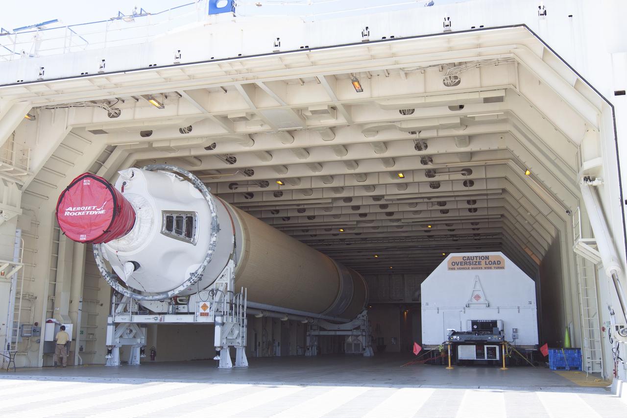 CAPE CANAVERAL, Fla. -- A barge arrives at the U.S. Army Outpost wharf at Port Canaveral in Florida, carrying the second stage, port booster and spacecraft adapter, the remaining stages for the United Launch Alliance Delta IV Heavy boosters for NASA’s upcoming Exploration Flight Test-1, or EFT-1, mission with the Orion spacecraft. They will be offloaded in their containers and transported to the Horizontal Integration Facility, or HIF, at Space Launch Complex 37 on Cape Canaveral Air Force Station. At the HIF, all three booster stages will be processed and checked out before being moved to the nearby launch pad and hoisted into position. The spacecraft adapter will connect Orion to the ULA Delta IV, and also will connect Orion to NASA's new rocket, the Space Launch System, on its first mission in 2017. During the EFT-1 mission, Orion will travel farther into space than any human spacecraft has gone in more than 40 years. The data gathered during the flight will influence design decisions, validate existing computer models and innovative new approaches to space systems development, as well as reduce overall mission risks and costs for later Orion flights. Liftoff of Orion on EFT-1 is planned for fall 2014. Photo credit: NASA/Kim Shiflett