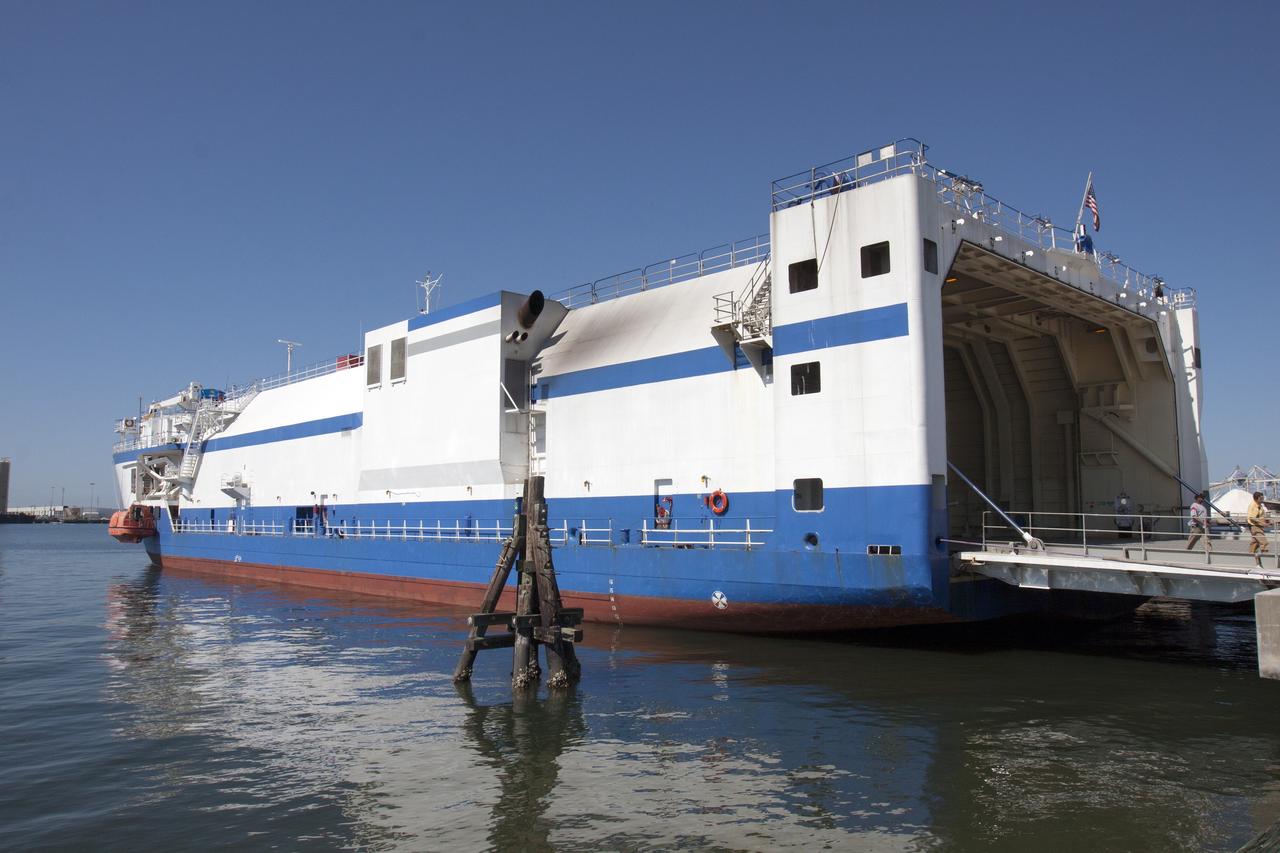 CAPE CANAVERAL, Fla. -- A barge arrives at the U.S. Army Outpost wharf at Port Canaveral in Florida, carrying the second stage, port booster and spacecraft adapter, the remaining stages for the United Launch Alliance Delta IV Heavy boosters for NASA’s upcoming Exploration Flight Test-1, or EFT-1, mission with the Orion spacecraft. They will be offloaded in their containers and transported to the Horizontal Integration Facility, or HIF, at Space Launch Complex 37 on Cape Canaveral Air Force Station. At the HIF, all three booster stages will be processed and checked out before being moved to the nearby launch pad and hoisted into position. The spacecraft adapter will connect Orion to the ULA Delta IV, and also will connect Orion to NASA's new rocket, the Space Launch System, on its first mission in 2017. During the EFT-1 mission, Orion will travel farther into space than any human spacecraft has gone in more than 40 years. The data gathered during the flight will influence design decisions, validate existing computer models and innovative new approaches to space systems development, as well as reduce overall mission risks and costs for later Orion flights. Liftoff of Orion on EFT-1 is planned for fall 2014. Photo credit: NASA/Kim Shiflett
