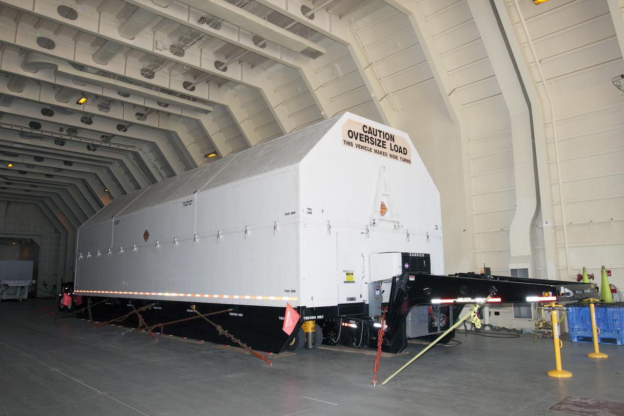 CAPE CANAVERAL, Fla. -- A barge has arrived at the U.S. Army Outpost wharf at Port Canaveral in Florida, carrying the second stage, port booster and spacecraft adapter, the remaining stages for the United Launch Alliance Delta IV Heavy boosters for NASA’s upcoming Exploration Flight Test-1, or EFT-1, mission with the Orion spacecraft. They are being offloaded in their containers for transport to the Horizontal Integration Facility, or HIF, at Space Launch Complex 37 on Cape Canaveral Air Force Station.    At the HIF, all three booster stages will be processed and checked out before being moved to the nearby launch pad and hoisted into position. The spacecraft adapter will connect Orion to the ULA Delta IV, and also will connect Orion to NASA's new rocket, the Space Launch System, on its first mission in 2017. During the EFT-1 mission, Orion will travel farther into space than any human spacecraft has gone in more than 40 years. The data gathered during the flight will influence design decisions, validate existing computer models and innovative new approaches to space systems development, as well as reduce overall mission risks and costs for later Orion flights. Liftoff of Orion on EFT-1 is planned for fall 2014. Photo credit: NASA/Kim Shiflett