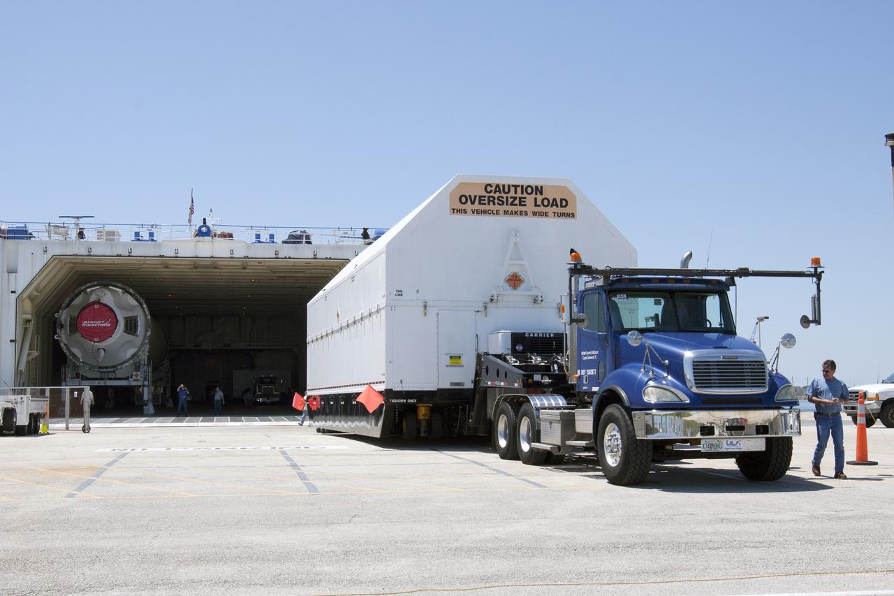 CAPE CANAVERAL, Fla. -- A barge has arrived at the U.S. Army Outpost wharf at Port Canaveral in Florida, carrying the second stage, port booster and spacecraft adapter, the remaining stages for the United Launch Alliance Delta IV Heavy boosters for NASA’s upcoming Exploration Flight Test-1, or EFT-1, mission with the Orion spacecraft. They are being offloaded in their containers for transport to the Horizontal Integration Facility, or HIF, at Space Launch Complex 37 on Cape Canaveral Air Force Station. At the HIF, all three booster stages will be processed and checked out before being moved to the nearby launch pad and hoisted into position. The spacecraft adapter will connect Orion to the ULA Delta IV, and also will connect Orion to NASA's new rocket, the Space Launch System, on its first mission in 2017. During the EFT-1 mission, Orion will travel farther into space than any human spacecraft has gone in more than 40 years. The data gathered during the flight will influence design decisions, validate existing computer models and innovative new approaches to space systems development, as well as reduce overall mission risks and costs for later Orion flights. Liftoff of Orion on EFT-1 is planned for fall 2014. Photo credit: NASA/Kim Shiflett