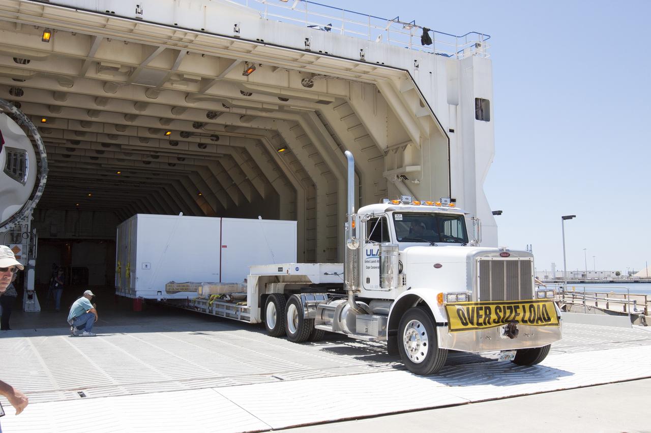 CAPE CANAVERAL, Fla. -- A barge has arrived at the U.S. Army Outpost wharf at Port Canaveral in Florida, carrying the second stage, port booster and spacecraft adapter, the remaining stages for the United Launch Alliance Delta IV Heavy boosters for NASA’s upcoming Exploration Flight Test-1, or EFT-1, mission with the Orion spacecraft. They are being offloaded in their containers for transport to the Horizontal Integration Facility, or HIF, at Space Launch Complex 37 on Cape Canaveral Air Force Station. At the HIF, all three booster stages will be processed and checked out before being moved to the nearby launch pad and hoisted into position. The spacecraft adapter will connect Orion to the ULA Delta IV, and also will connect Orion to NASA's new rocket, the Space Launch System, on its first mission in 2017. During the EFT-1 mission, Orion will travel farther into space than any human spacecraft has gone in more than 40 years. The data gathered during the flight will influence design decisions, validate existing computer models and innovative new approaches to space systems development, as well as reduce overall mission risks and costs for later Orion flights. Liftoff of Orion on EFT-1 is planned for fall 2014. Photo credit: NASA/Kim Shiflett