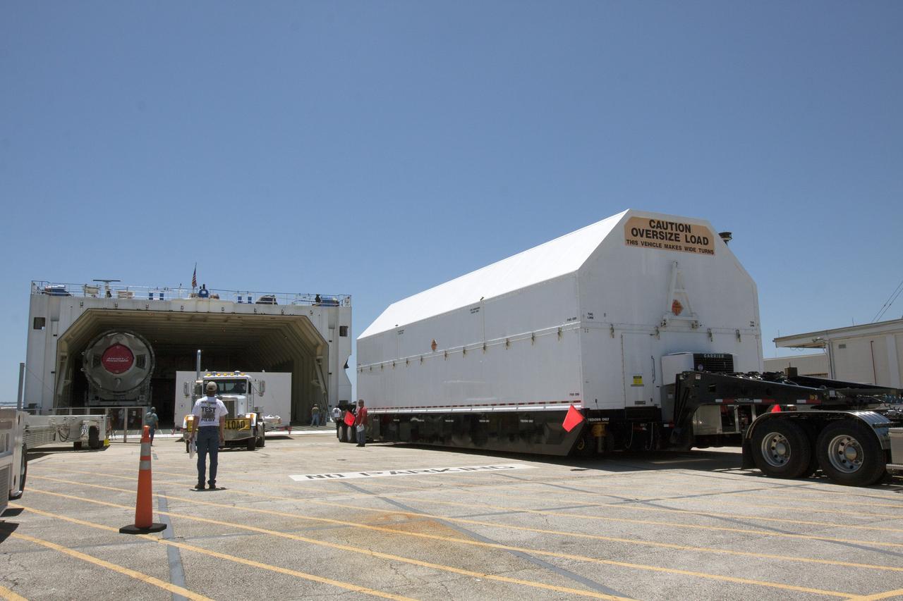 CAPE CANAVERAL, Fla. -- A barge has arrived at the U.S. Army Outpost wharf at Port Canaveral in Florida, carrying the second stage, port booster and spacecraft adapter, the remaining stages for the United Launch Alliance Delta IV Heavy boosters for NASA’s upcoming Exploration Flight Test-1, or EFT-1, mission with the Orion spacecraft. The segments are being offloaded in their containers for transport to the Horizontal Integration Facility, or HIF, at Space Launch Complex 37 on Cape Canaveral Air Force Station. At the HIF, all three booster stages will be processed and checked out before being moved to the nearby launch pad and hoisted into position. The spacecraft adapter will connect Orion to the ULA Delta IV, and also will connect Orion to NASA's new rocket, the Space Launch System, on its first mission in 2017. During the EFT-1 mission, Orion will travel farther into space than any human spacecraft has gone in more than 40 years. The data gathered during the flight will influence design decisions, validate existing computer models and innovative new approaches to space systems development, as well as reduce overall mission risks and costs for later Orion flights. Liftoff of Orion on EFT-1 is planned for fall 2014. Photo credit: NASA/Kim Shiflett