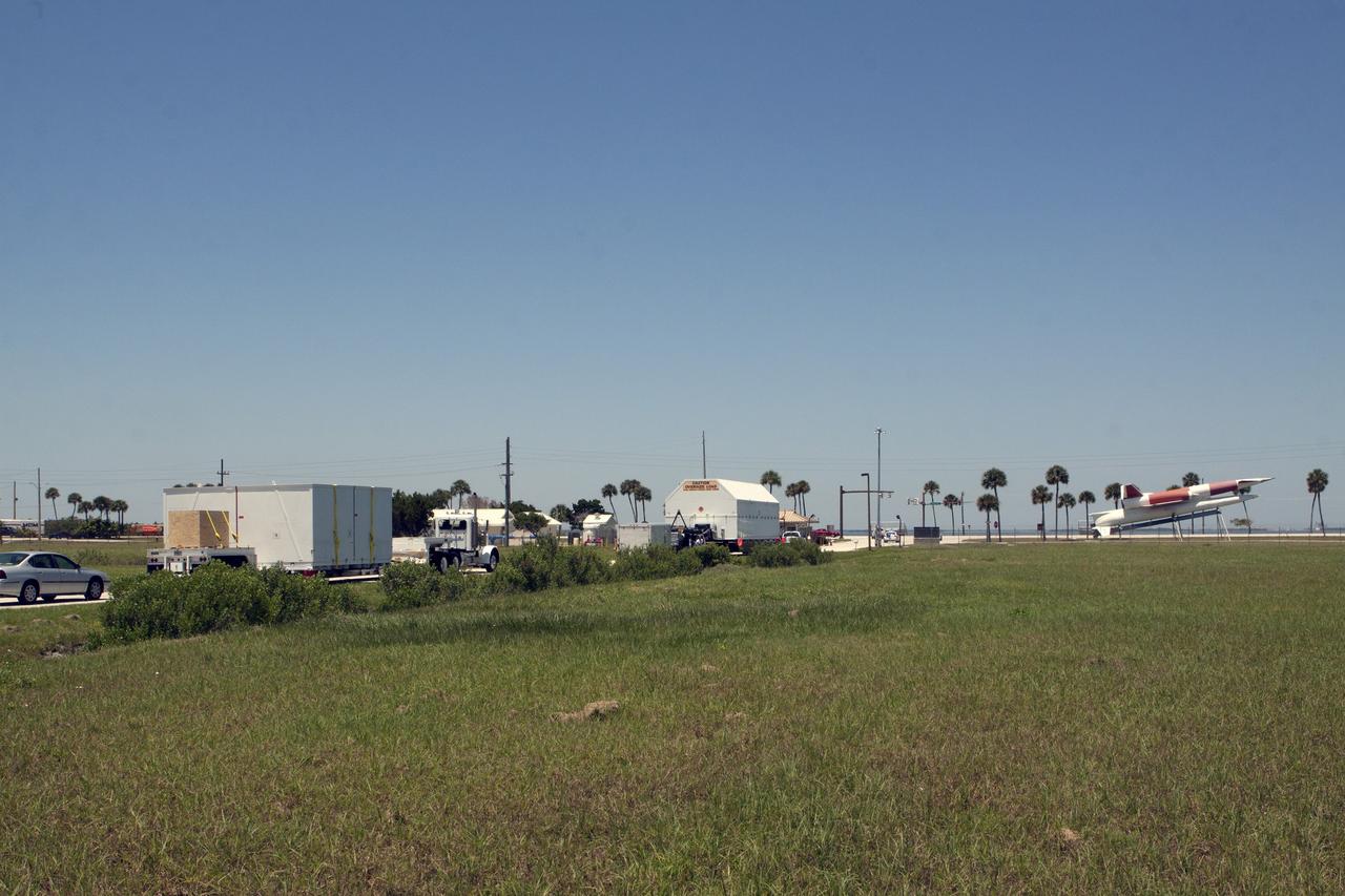 CAPE CANAVERAL, Fla. -- After arriving by barge at the U.S. Army Outpost wharf at Port Canaveral in Florida, the second stage, port booster and spacecraft adapter, the remaining stages for the United Launch Alliance Delta IV Heavy boosters for NASA’s upcoming Exploration Flight Test-1, or EFT-1, mission with the Orion spacecraft, were offloaded in their containers. They are being transported to the Horizontal Integration Facility, or HIF, at Space Launch Complex 37 on Cape Canaveral Air Force Station. At the HIF, all three booster stages will be processed and checked out before being moved to the nearby launch pad and hoisted into position. The spacecraft adapter will connect Orion to the ULA Delta IV, and also will connect Orion to NASA's new rocket, the Space Launch System, on its first mission in 2017. During the EFT-1 mission, Orion will travel farther into space than any human spacecraft has gone in more than 40 years. The data gathered during the flight will influence design decisions, validate existing computer models and innovative new approaches to space systems development, as well as reduce overall mission risks and costs for later Orion flights. Liftoff of Orion on EFT-1 is planned for fall 2014. Photo credit: NASA/Kim Shiflett
