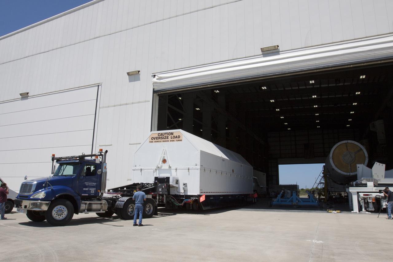 CAPE CANAVERAL, Fla. -- The second stage, port booster and spacecraft adapter, the remaining stages for the United Launch Alliance Delta IV Heavy boosters for NASA’s upcoming Exploration Flight Test-1, or EFT-1, mission with the Orion spacecraft, have been transported in their containers to the Horizontal Integration Facility, or HIF, at Space Launch Complex 37 on Cape Canaveral Air Force Station in Florida. The segments arrived by barge at the U.S. Army Outpost wharf at Port Canaveral. At the HIF, all three booster stages will be processed and checked out before being moved to the nearby launch pad and hoisted into position. The spacecraft adapter will connect Orion to the ULA Delta IV, and also will connect Orion to NASA's new rocket, the Space Launch System, on its first mission in 2017. During the EFT-1 mission, Orion will travel farther into space than any human spacecraft has gone in more than 40 years. The data gathered during the flight will influence design decisions, validate existing computer models and innovative new approaches to space systems development, as well as reduce overall mission risks and costs for later Orion flights. Liftoff of Orion on EFT-1 is planned for fall 2014. Photo credit: NASA/Kim Shiflett