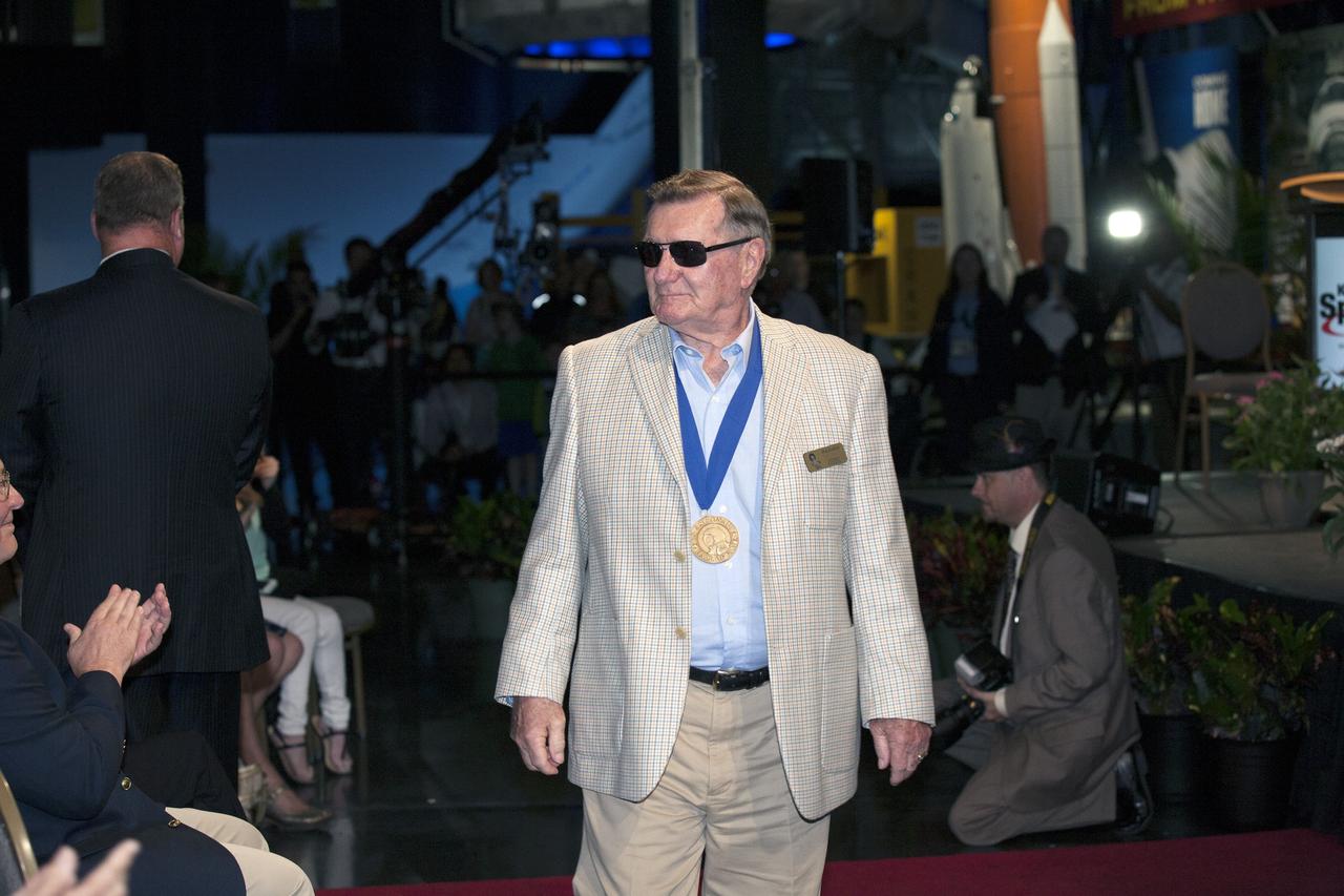 CAPE CANAVERAL, Fla. -- Inside the Space Shuttle Atlantis attraction at NASA’s Kennedy Space Center Visitor Complex in Florida, former NASA astronaut and Hall of Famer Dick Gordon walks the red carpet at the 2014 U.S. Astronaut Hall of Fame Induction ceremony. Space shuttle astronauts and space explorers Shannon Lucid and Jerry Ross were inducted into the Hall of Fame Class of 2014. The 2014 inductees are selected by a committee of Hall of Fame astronauts, former NASA officials, flight directors, historians and journalists. The process is administered by the Astronaut Scholarship Foundation. To be eligible, an astronaut must have made his or her first flight at least 17 years before the induction. Candidates must be a U.S. citizen and a NASA-trained commander, pilot or mission specialist who has orbited the earth at least once. Including Lucid and Ross, 87 astronauts have been inducted into the AHOF. Photo credit: NASA/Kim Shiflett