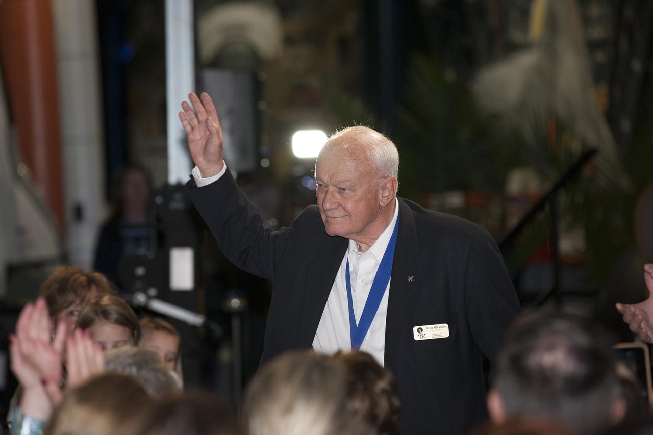 CAPE CANAVERAL, Fla. -- Inside the Space Shuttle Atlantis attraction at NASA’s Kennedy Space Center Visitor Complex in Florida, former NASA astronaut and Hall of Famer Bruce McCandless walks the red carpet at the 2014 U.S. Astronaut Hall of Fame Induction ceremony. Space shuttle astronauts and space explorers Shannon Lucid and Jerry Ross were inducted into the Hall of Fame Class of 2014.    The 2014 inductees are selected by a committee of Hall of Fame astronauts, former NASA officials, flight directors, historians and journalists. The process is administered by the Astronaut Scholarship Foundation. To be eligible, an astronaut must have made his or her first flight at least 17 years before the induction. Candidates must be a U.S. citizen and a NASA-trained commander, pilot or mission specialist who has orbited the earth at least once. Including Lucid and Ross, 87 astronauts have been inducted into the AHOF.  Photo credit: NASA/Kim Shiflett