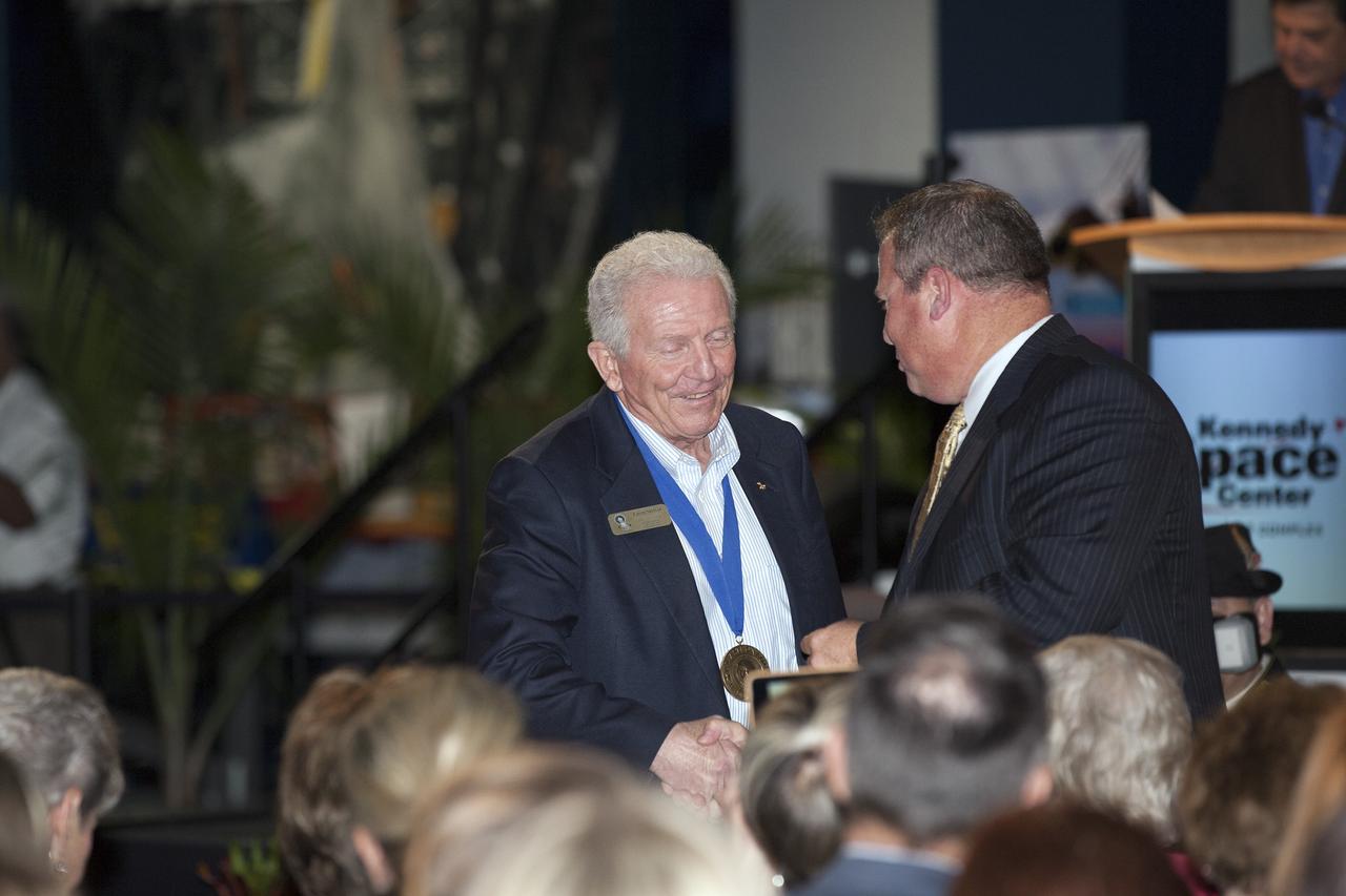 CAPE CANAVERAL, Fla. -- Inside the Space Shuttle Atlantis attraction at NASA’s Kennedy Space Center Visitor Complex in Florida, former NASA astronaut and Hall of Famer Loren Shriver walks the red carpet at the 2014 U.S. Astronaut Hall of Fame Induction ceremony. Space shuttle astronauts and space explorers Shannon Lucid and Jerry Ross were inducted into the Hall of Fame Class of 2014. The 2014 inductees are selected by a committee of Hall of Fame astronauts, former NASA officials, flight directors, historians and journalists. The process is administered by the Astronaut Scholarship Foundation. To be eligible, an astronaut must have made his or her first flight at least 17 years before the induction. Candidates must be a U.S. citizen and a NASA-trained commander, pilot or mission specialist who has orbited the earth at least once. Including Lucid and Ross, 87 astronauts have been inducted into the AHOF. Photo credit: NASA/Kim Shiflett