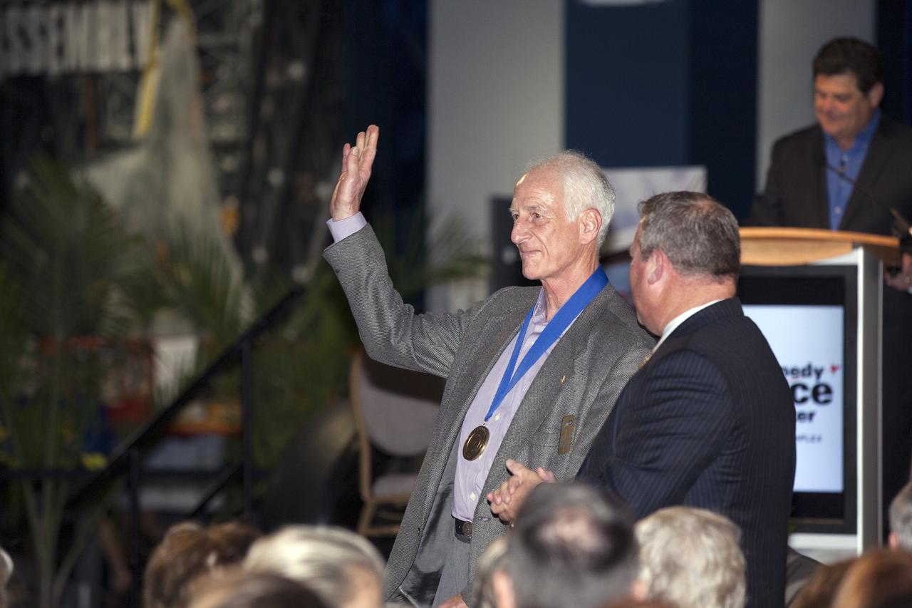 CAPE CANAVERAL, Fla. -- Inside the Space Shuttle Atlantis attraction at NASA’s Kennedy Space Center Visitor Complex in Florida, former NASA astronaut and Hall of Famer Jeff Hoffman walks the red carpet at the 2014 U.S. Astronaut Hall of Fame Induction ceremony. Space shuttle astronauts and space explorers Shannon Lucid and Jerry Ross were inducted into the Hall of Fame Class of 2014.    The 2014 inductees are selected by a committee of Hall of Fame astronauts, former NASA officials, flight directors, historians and journalists. The process is administered by the Astronaut Scholarship Foundation. To be eligible, an astronaut must have made his or her first flight at least 17 years before the induction. Candidates must be a U.S. citizen and a NASA-trained commander, pilot or mission specialist who has orbited the earth at least once. Including Lucid and Ross, 87 astronauts have been inducted into the AHOF.  Photo credit: NASA/Kim Shiflett
