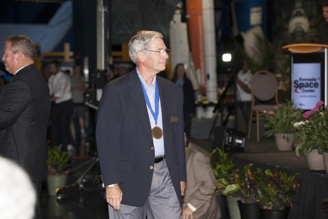 CAPE CANAVERAL, Fla. -- Inside the Space Shuttle Atlantis attraction at NASA’s Kennedy Space Center Visitor Complex in Florida, former NASA astronaut and Hall of Famer John Blaha walks the red carpet at the 2014 U.S. Astronaut Hall of Fame Induction ceremony. Space shuttle astronauts and space explorers Shannon Lucid and Jerry Ross were inducted into the Hall of Fame Class of 2014. The 2014 inductees are selected by a committee of Hall of Fame astronauts, former NASA officials, flight directors, historians and journalists. The process is administered by the Astronaut Scholarship Foundation. To be eligible, an astronaut must have made his or her first flight at least 17 years before the induction. Candidates must be a U.S. citizen and a NASA-trained commander, pilot or mission specialist who has orbited the earth at least once. Including Lucid and Ross, 87 astronauts have been inducted into the AHOF. Photo credit: NASA/Kim Shiflett