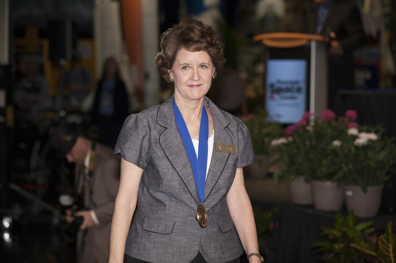 CAPE CANAVERAL, Fla. -- Inside the Space Shuttle Atlantis attraction at NASA’s Kennedy Space Center Visitor Complex in Florida, former NASA astronaut and Hall of Famer Kathy Thornton walks the red carpet at the 2014 U.S. Astronaut Hall of Fame Induction ceremony. Space shuttle astronauts and space explorers Shannon Lucid and Jerry Ross were inducted into the Hall of Fame Class of 2014.    The 2014 inductees are selected by a committee of Hall of Fame astronauts, former NASA officials, flight directors, historians and journalists. The process is administered by the Astronaut Scholarship Foundation. To be eligible, an astronaut must have made his or her first flight at least 17 years before the induction. Candidates must be a U.S. citizen and a NASA-trained commander, pilot or mission specialist who has orbited the earth at least once. Including Lucid and Ross, 87 astronauts have been inducted into the AHOF.  Photo credit: NASA/Kim Shiflett
