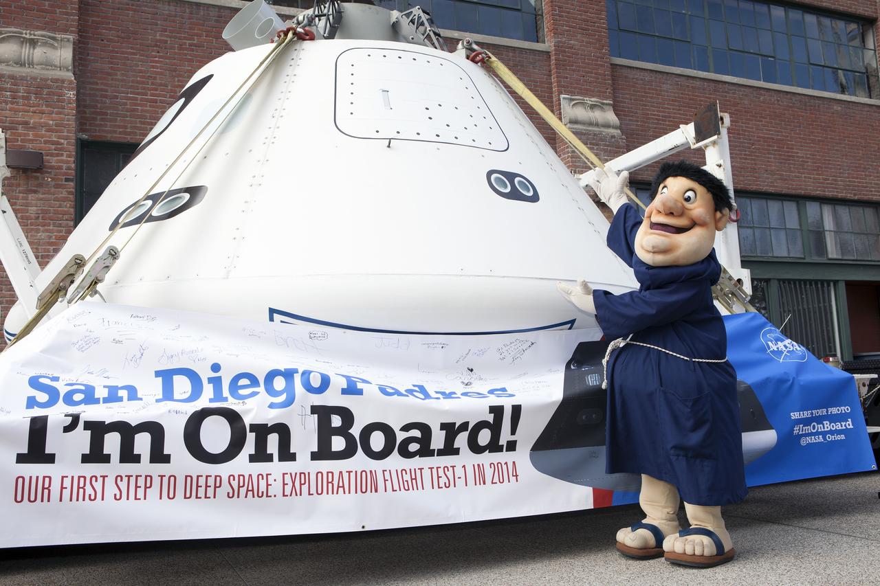 CAPE CANAVERAL, Fla. – The San Diego Padres' mascot checks out NASA's Orion boilerplate test vehicle inside Petco Park in San Diego, California. The boilerplate test vehicle is being prepared for an Exploration Flight Test-1, or EFT-1, pre-transportation test. The Ground Systems Development and Operations Program will run the test at the U.S. Naval Base San Diego to simulate retrieval and transportation procedures for Orion after it splashes down in the ocean and is retrieved for return to land and ground transportation back to Kennedy Space Center in Florida.    Orion is the exploration spacecraft designed to carry astronauts to destinations not yet explored by humans, including an asteroid and Mars. It will have emergency abort capability, sustain the crew during space travel and provide safe re-entry from deep space return velocities. The first unpiloted test flight of the Orion is scheduled to launch later this year atop a Delta IV rocket and in 2017 on NASA’s Space Launch System rocket. For more information, visit http://www.nasa.gov/orion. Photo credit: NASA/Kim Shiflett