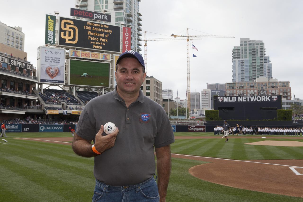 CAPE CANAVERAL, Fla. – Doug Lenhardt, Kennedy Space Center's Exploration Flight Test-1, or EFT-1, mission integration manager displays a baseball from the San Diego Padres inside Petco Park in San Diego, California. NASA's Orion boilerplate test vehicle is on display at the stadium. The boilerplate test vehicle is being prepared for an EFT-1 pre-transportation test. The Ground Systems Development and Operations Program will run the test to simulate retrieval and transportation procedures for Orion after it splashes down in the ocean and is retrieved for return to land and ground transportation back to Kennedy Space Center in Florida.    Orion is the exploration spacecraft designed to carry astronauts to destinations not yet explored by humans, including an asteroid and Mars. It will have emergency abort capability, sustain the crew during space travel and provide safe re-entry from deep space return velocities. The first unpiloted test flight of the Orion is scheduled to launch later this year atop a Delta IV rocket and in 2017 on NASA’s Space Launch System rocket. For more information, visit http://www.nasa.gov/orion. Photo credit: NASA/Kim Shiflett