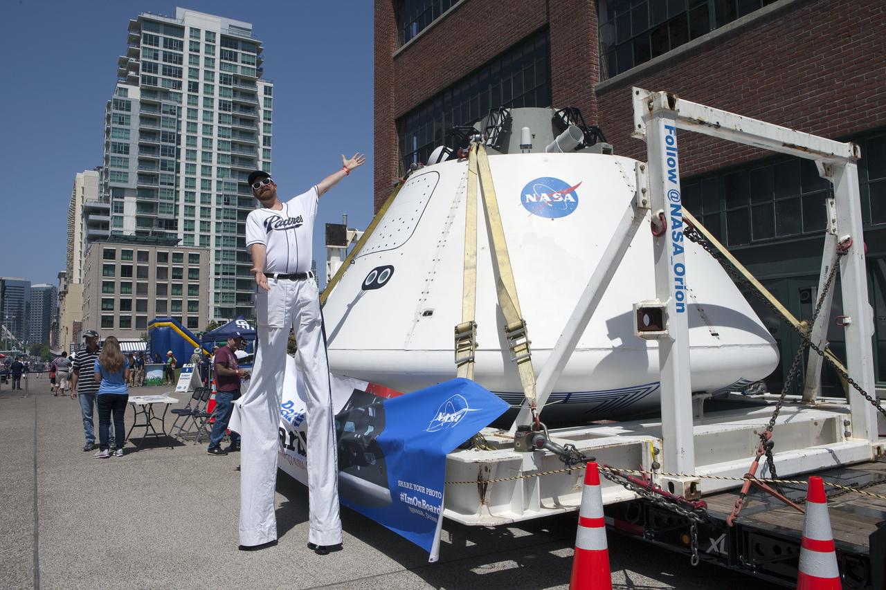 CAPE CANAVERAL, Fla. – A San Diego Padres fan on stilts stands near NASA's Orion boilerplate test vehicle on display at Petco Park in San Diego, California. The boilerplate test vehicle will be prepared for an Exploration Flight Test-1, or EFT-1, pre-transportation test. The Ground Systems Development and Operations Program will run the test at the U.S. Naval Base San Diego to simulate retrieval and transportation procedures for Orion after it splashes down in the ocean and is retrieved for return to land and ground transportation back to Kennedy Space Center in Florida.    Orion is the exploration spacecraft designed to carry astronauts to destinations not yet explored by humans, including an asteroid and Mars. It will have emergency abort capability, sustain the crew during space travel and provide safe re-entry from deep space return velocities. The first unpiloted test flight of the Orion is scheduled to launch later this year atop a Delta IV rocket and in 2017 on NASA’s Space Launch System rocket. For more information, visit http://www.nasa.gov/orion. Photo credit: NASA/Kim Shiflett