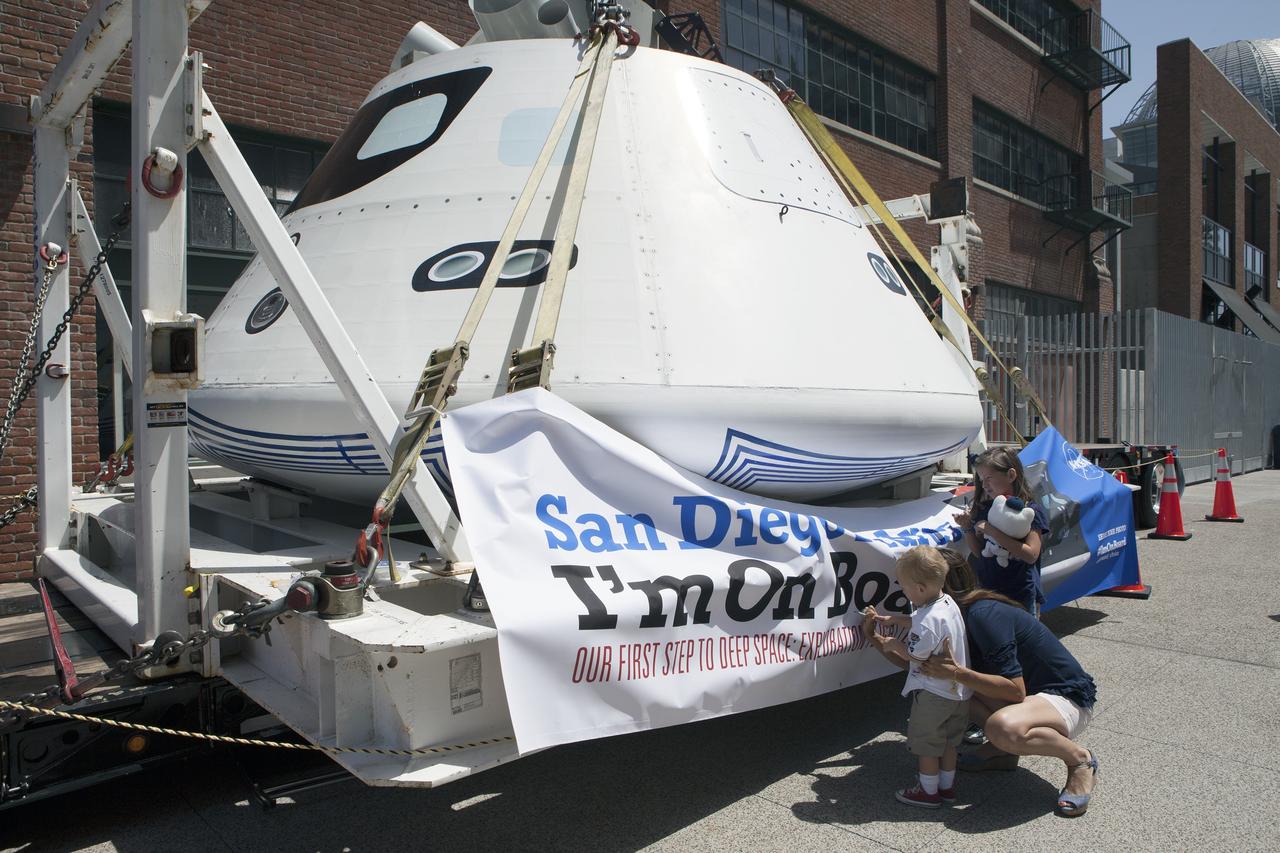 CAPE CANAVERAL, Fla. – Fans sign the banner draped around NASA's Orion boilerplate test vehicle on display at the San Diego Padres Petco Field in San Diego, California, before the start of the baseball game. The test vehicle is being prepared for an Exploration Flight Test-1, or EFT-1, pre-transportation test. The Ground Systems Development and Operations Program will run the test at the U.S. Naval Base San Diego to simulate retrieval and transportation procedures for Orion after it splashes down in the ocean and is retrieved for return to land and ground transportation back to Kennedy Space Center in Florida.    Orion is the exploration spacecraft designed to carry astronauts to destinations not yet explored by humans, including an asteroid and Mars. It will have emergency abort capability, sustain the crew during space travel and provide safe re-entry from deep space return velocities. The first unpiloted test flight of the Orion is scheduled to launch later this year atop a Delta IV rocket and in 2017 on NASA’s Space Launch System rocket. For more information, visit http://www.nasa.gov/orion. Photo credit: NASA/Kim Shiflett