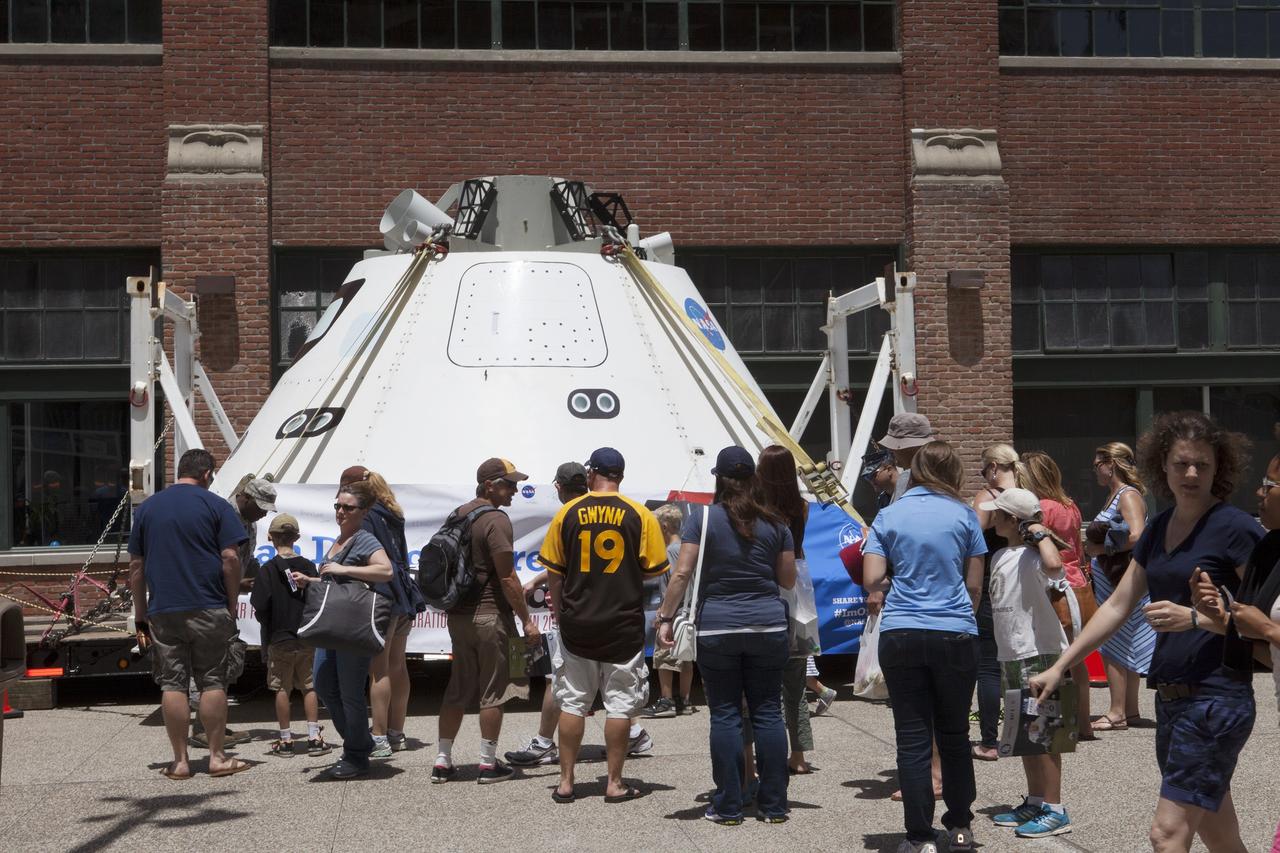 CAPE CANAVERAL, Fla. – Fans check out NASA's Orion boilerplate test vehicle on display at Petco Park in San Diego, California, before the start of a San Diego Padres' baseball game. The boilerplate test vehicle is being prepared for an Exploration Flight Test-1, or EFT-1, pre-transportation test. The Ground Systems Development and Operations Program will run the test at the U.S. Naval Base San Diego to simulate retrieval and transportation procedures for Orion after it splashes down in the ocean and is retrieved for return to land and ground transportation back to Kennedy Space Center in Florida.     Orion is the exploration spacecraft designed to carry astronauts to destinations not yet explored by humans, including an asteroid and Mars. It will have emergency abort capability, sustain the crew during space travel and provide safe re-entry from deep space return velocities. The first unpiloted test flight of the Orion is scheduled to launch later this year atop a Delta IV rocket and in 2017 on NASA’s Space Launch System rocket. For more information, visit http://www.nasa.gov/orion. Photo credit: NASA/Kim Shiflett