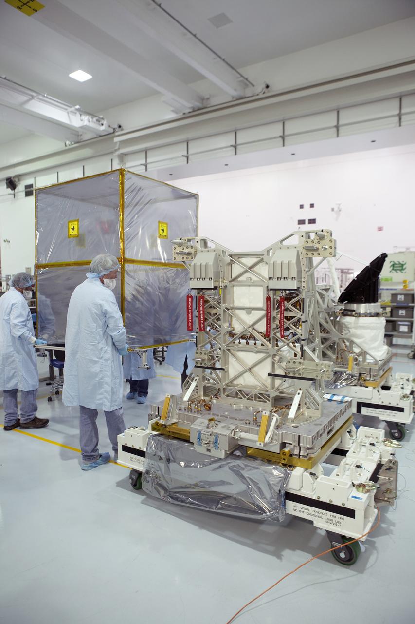 CAPE CANAVERAL, Fla. – Payload technicians and Jet Propulsion Laboratory personnel set aside a shipping cover after removing it from NASA's International Space Station-RapidScat scatterometer instrument inside Kennedy Space Center's Space Station Processing Facility. ISS-RapidScat is the first scientific Earth-observing instrument designed to operate from the exterior of the space station. It will measure Earth's ocean surface wind speed and direction, providing data to be used in weather and marine forecasting. Built at NASA's Jet Propulsion Laboratory, ISS-RapidScat is slated to fly on the SpaceX-4 commercial cargo resupply flight in 2014. For more information, visit http://www.jpl.nasa.gov/missions/iss-rapidscat. Photo credit: NASA/Dimitri Gerondidakis
